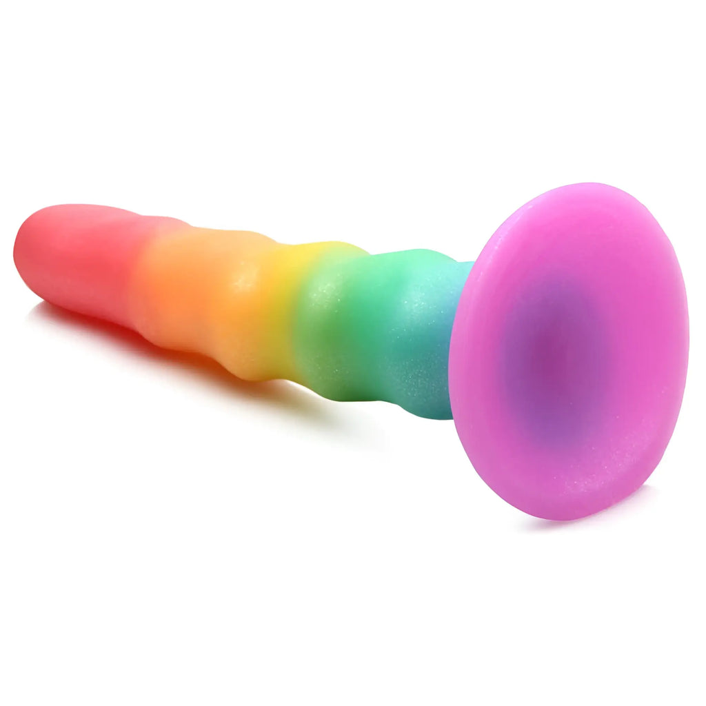 Curve Toys Zigzag rainbow silicone dildo featuring a textured, multicolored shaft and a round pink suction cup base.