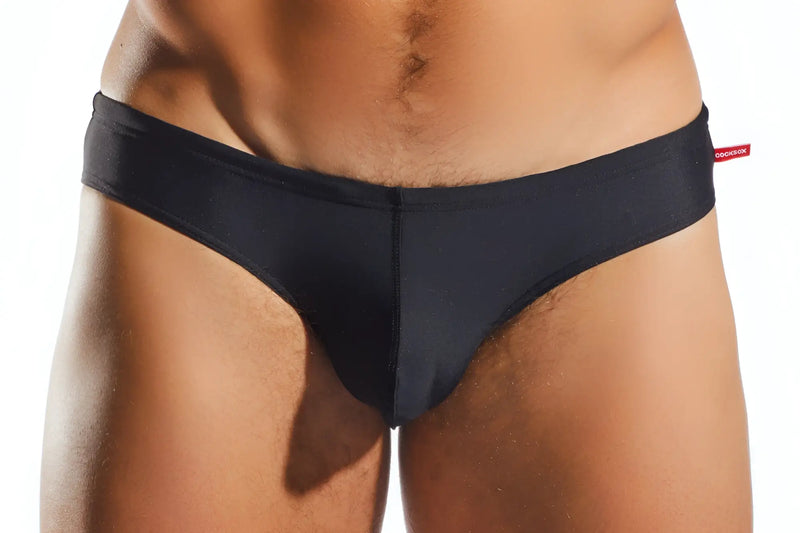 Black smooth-textured CX04 drawstring swim brief with subtle center seam and red brand tag on waistband