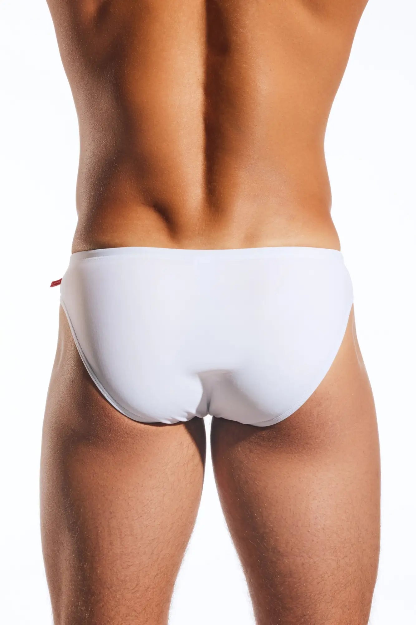 White CX04 drawstring swim brief with a subtle red tab on the side designed for comfortable beachwear
