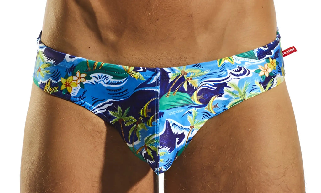 Cx04pr drawstring swim brief with vibrant blue tropical print featuring green yellow and white palm trees and waves