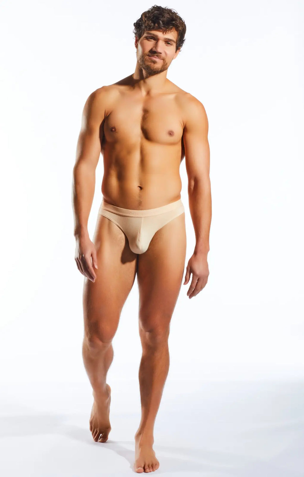 Beige cotton thong cx05md with smooth form-fitting design for comfortable everyday wear showing front side