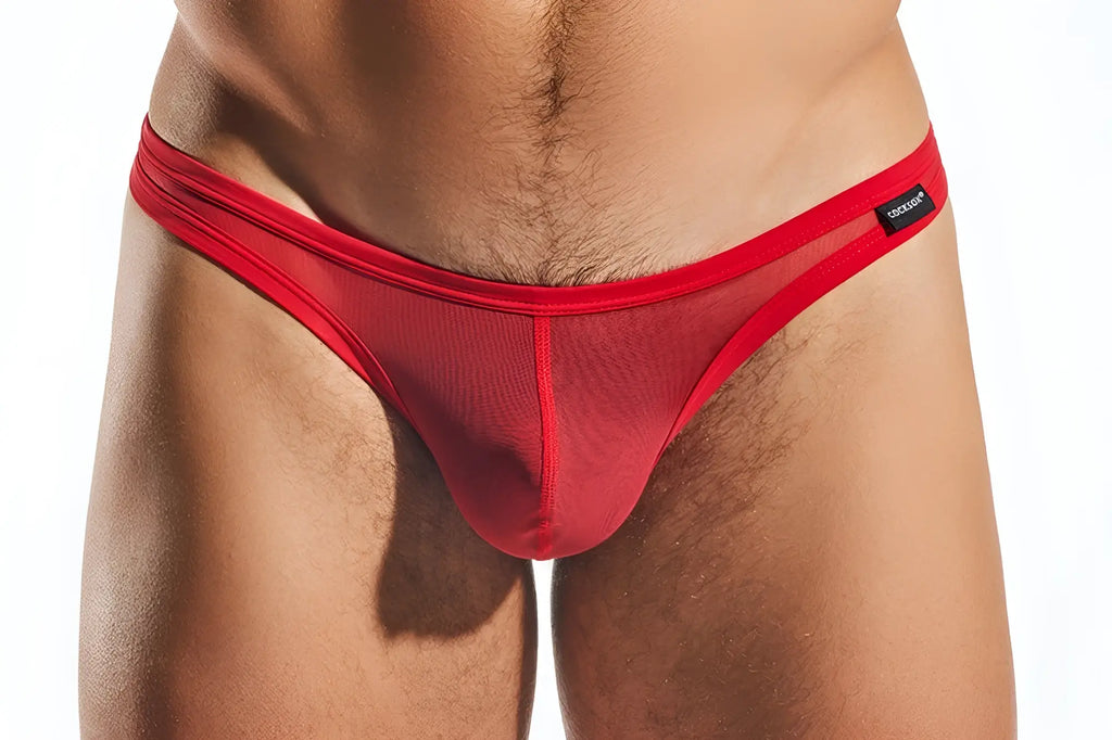 Red mesh thong cx05me with solid red waistband and black brand tag shown from the front view