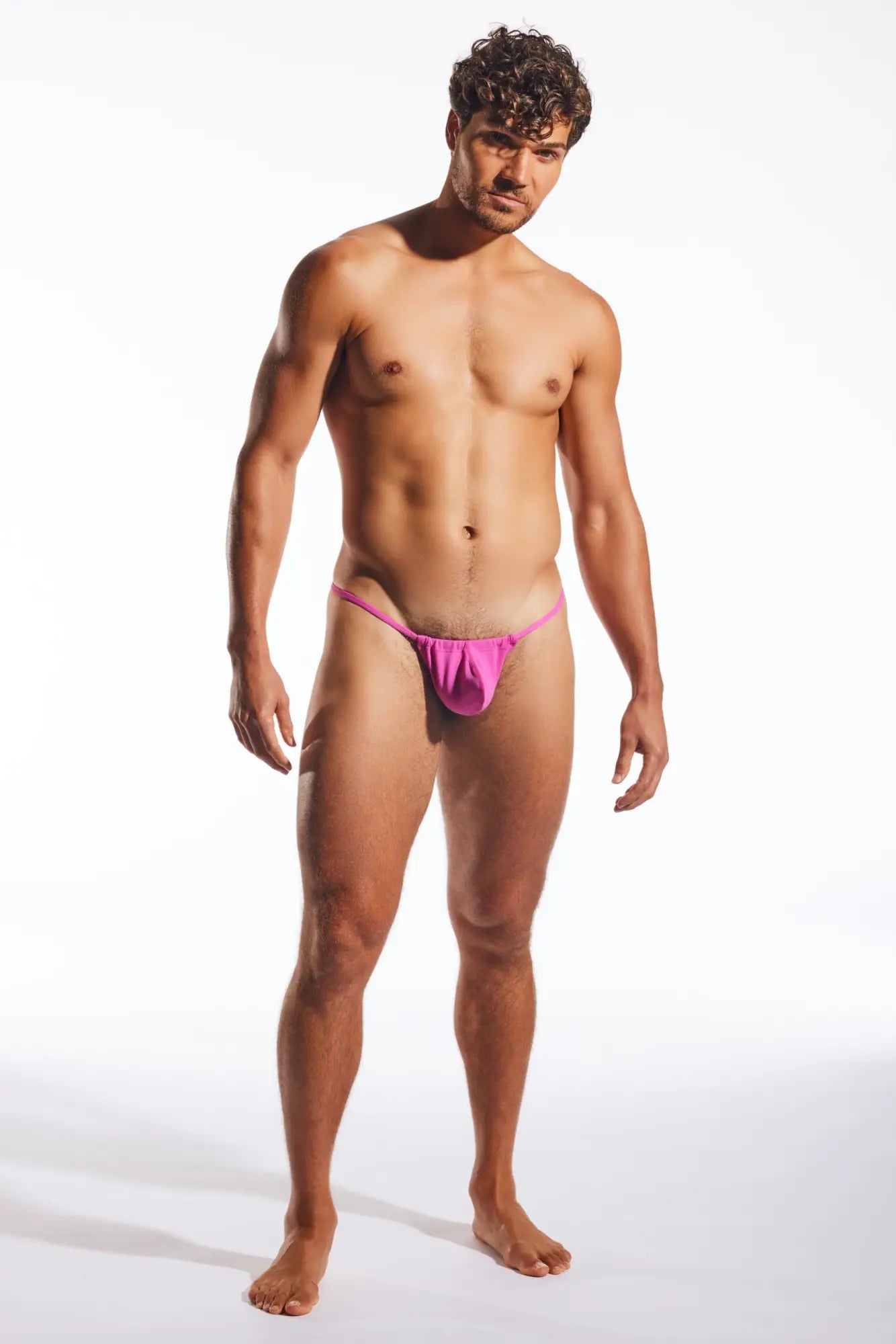 Vibrant pink cx14 slingshot thong made of smooth stretchy fabric showing the back side of the product