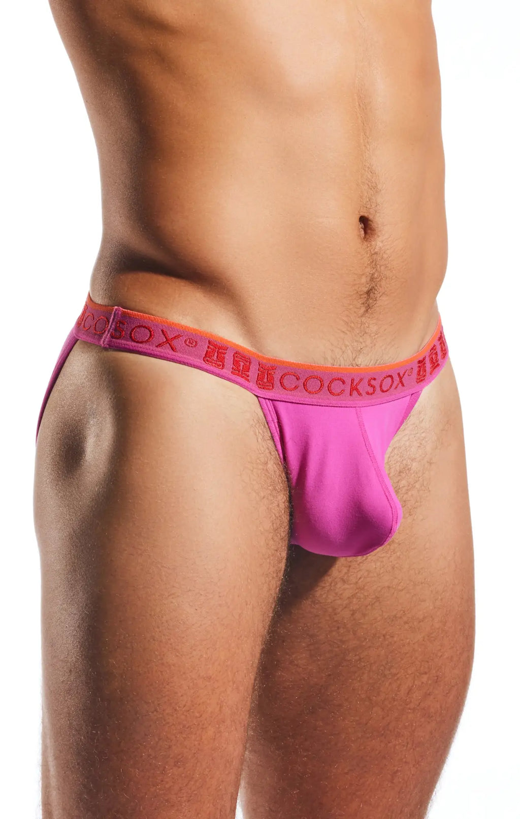 Bright pink cocksox men’s bikini briefs with an orange waistband featuring repeating brand name cx16n design