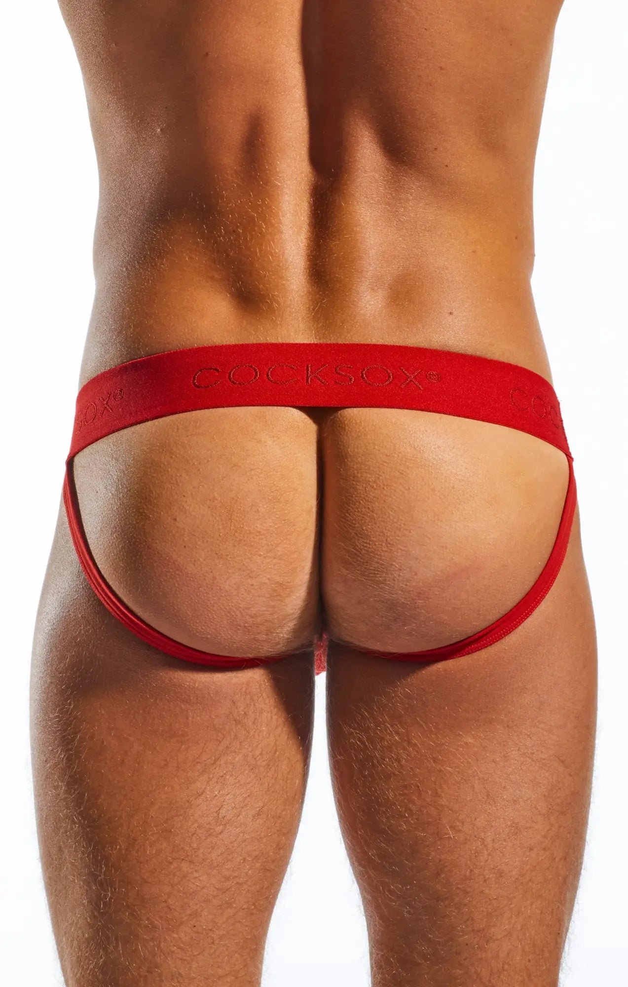 Red cocksox cx21n jockstrap thong with smooth elastic fabric waistband and leg straps visible from the back