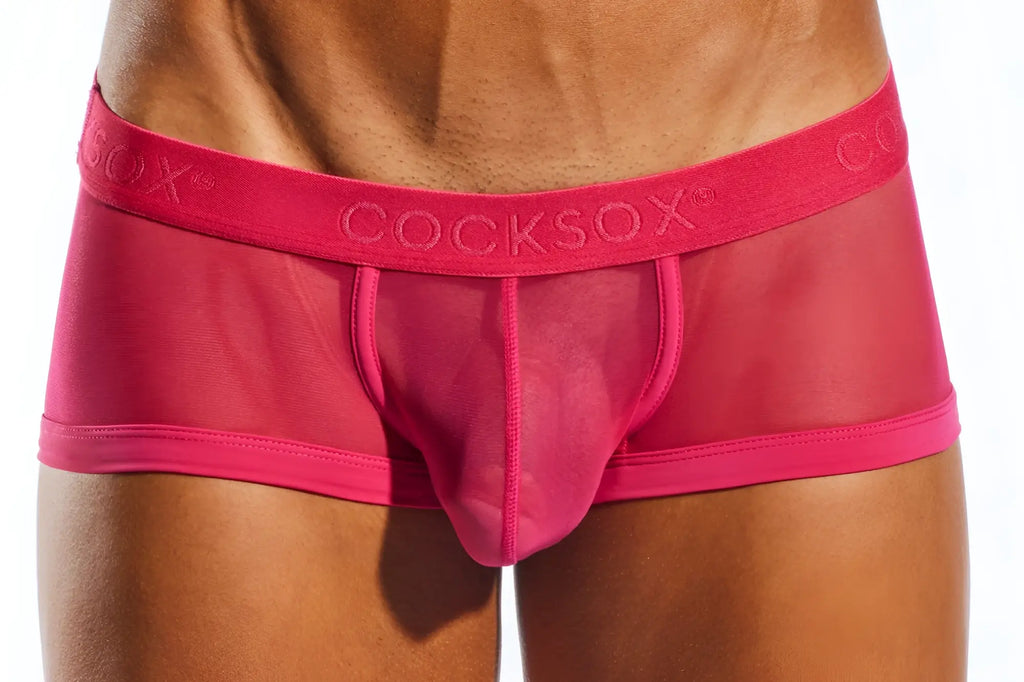 Bright pink transparent mesh briefs with a solid pink waistband featuring the cocksox brand name cx68me mesh trunk
