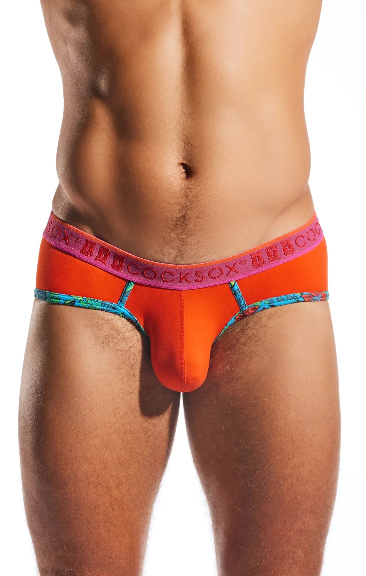 Bright orange cx76n sports briefs with blue patterned trim and pink waistband featuring cocksox logo