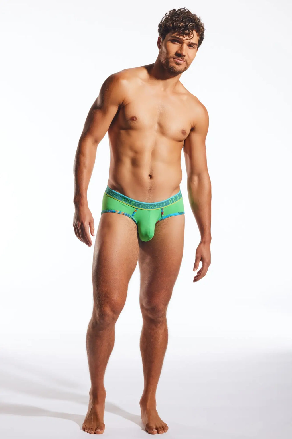 Green cx76n sports brief with vibrant fabric and teal waistband featuring subtle branding for active wear