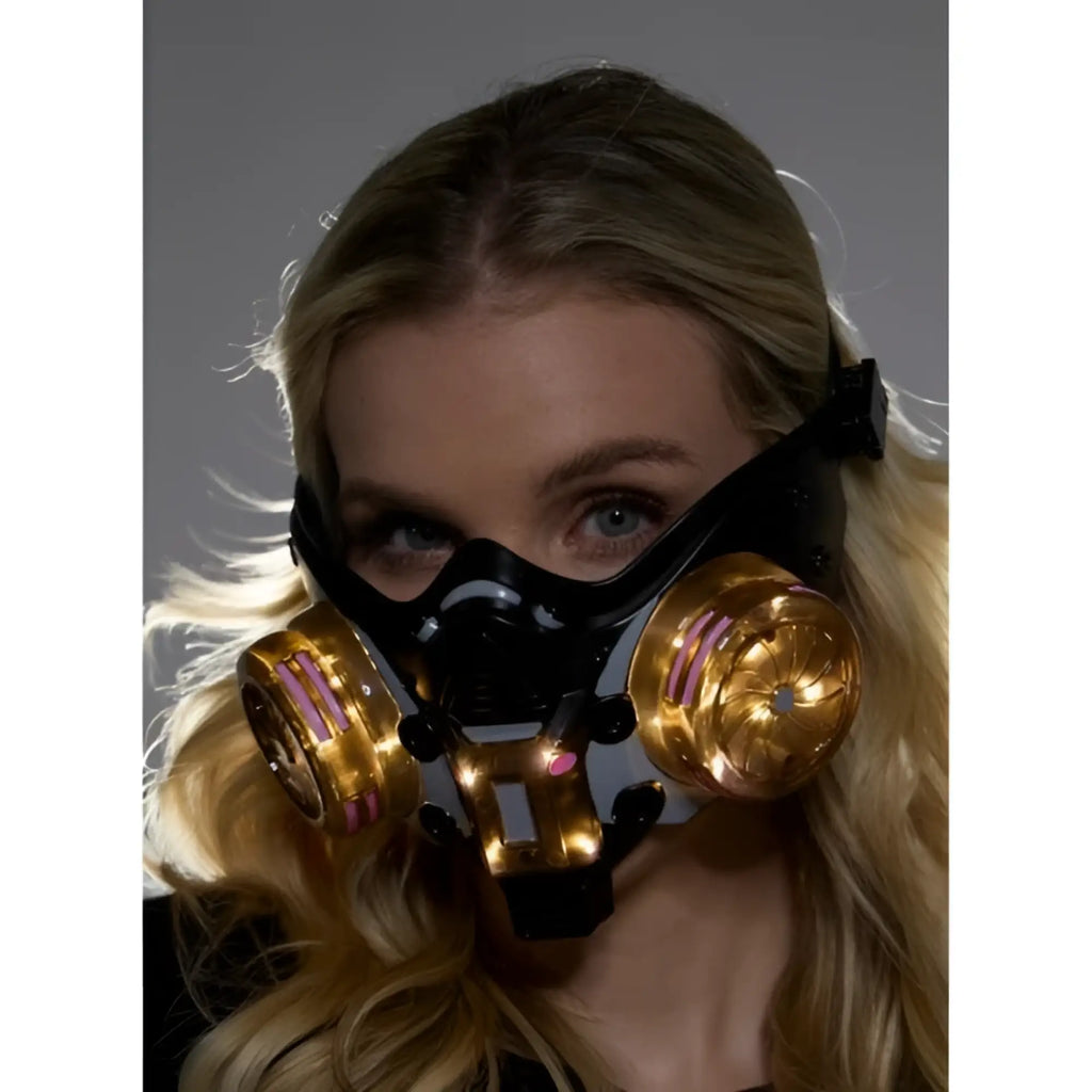Cyberpunk light up mask black and gold futuristic gas mask with glowing pink accents on circular filters