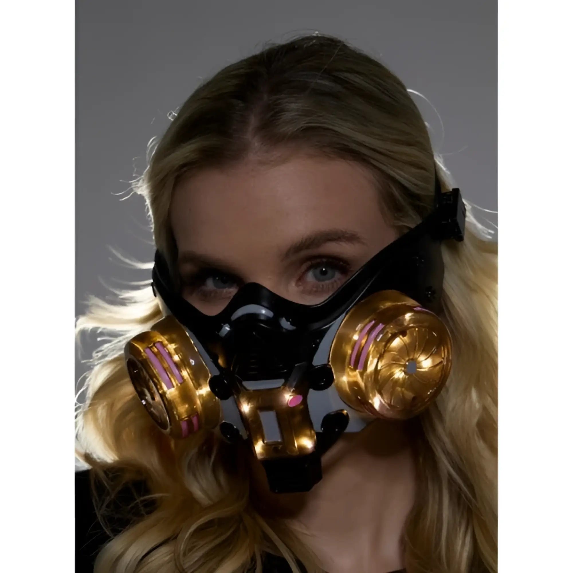 Cyberpunk light up mask black and gold futuristic gas mask with glowing pink accents on circular filters