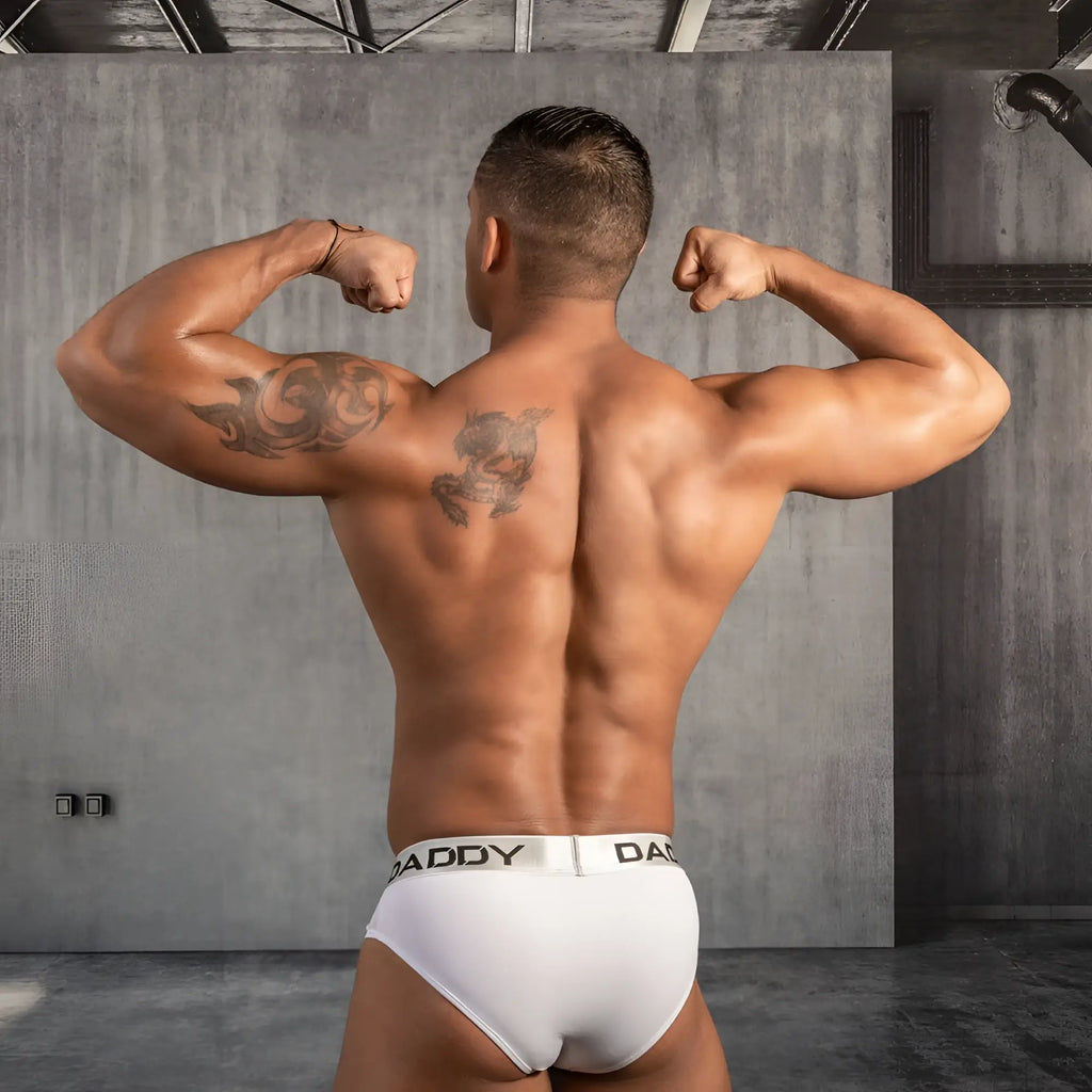 White daddy underwear bikini brief with black daddy logo on waistband showing front side design