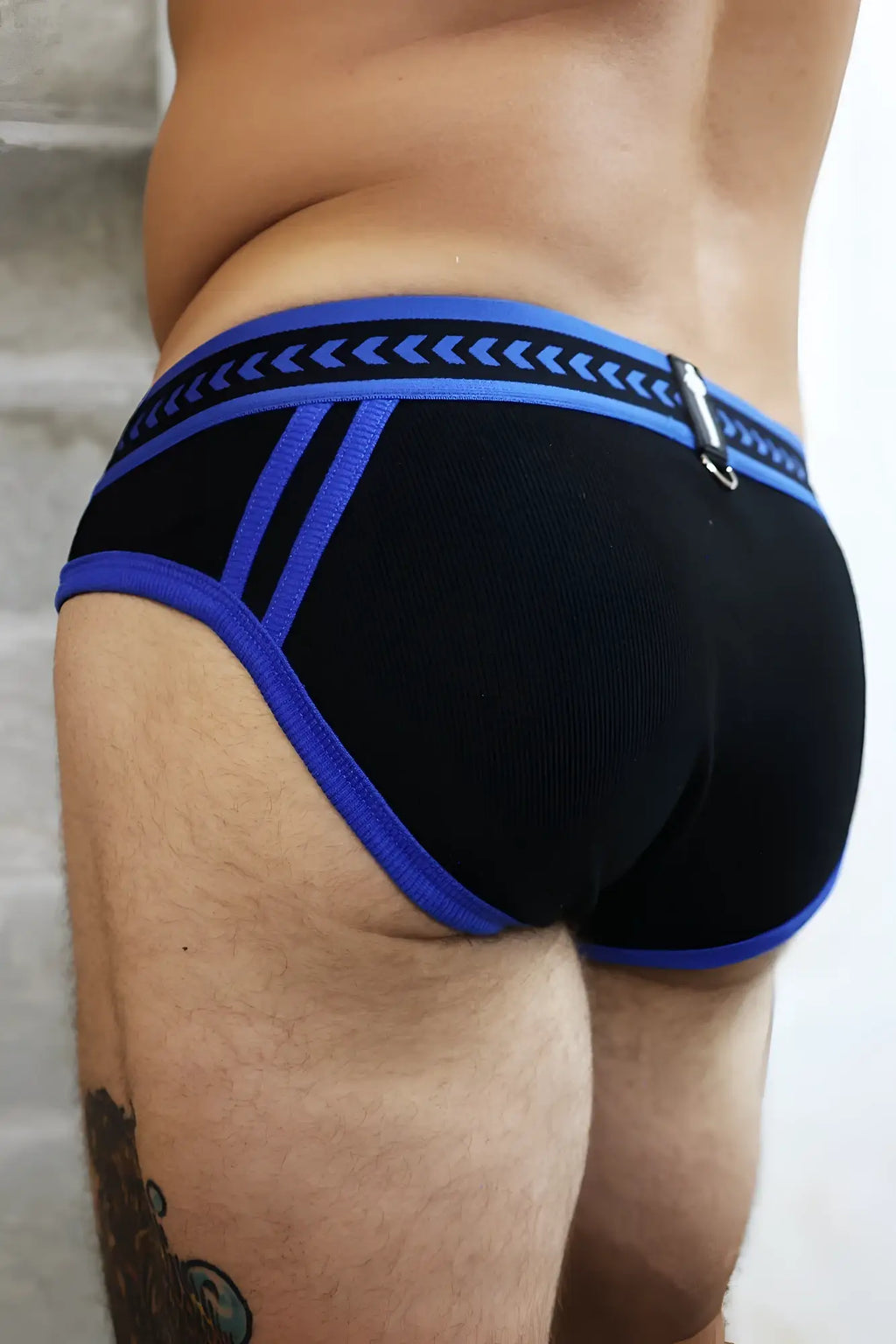 Black and blue daddy’s favorite briefs with textured waistband featuring arrow patterns in athletic style