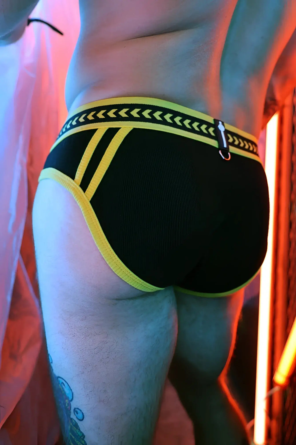 Black briefs with bold yellow trim and patterned waistband featuring arrow motifs from daddys favorite briefs