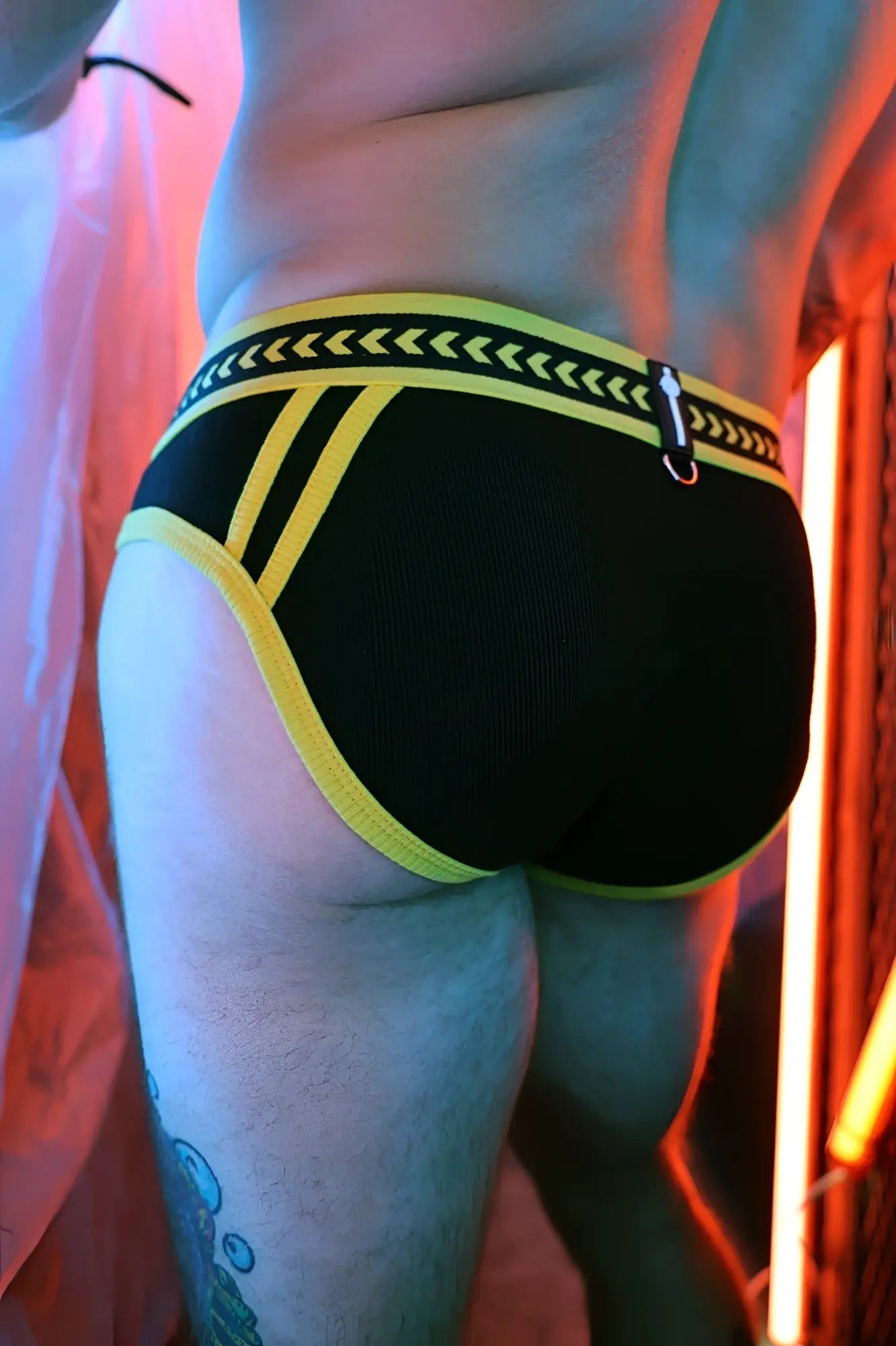 Black briefs with bold yellow trim and patterned waistband featuring arrow motifs from daddys favorite briefs