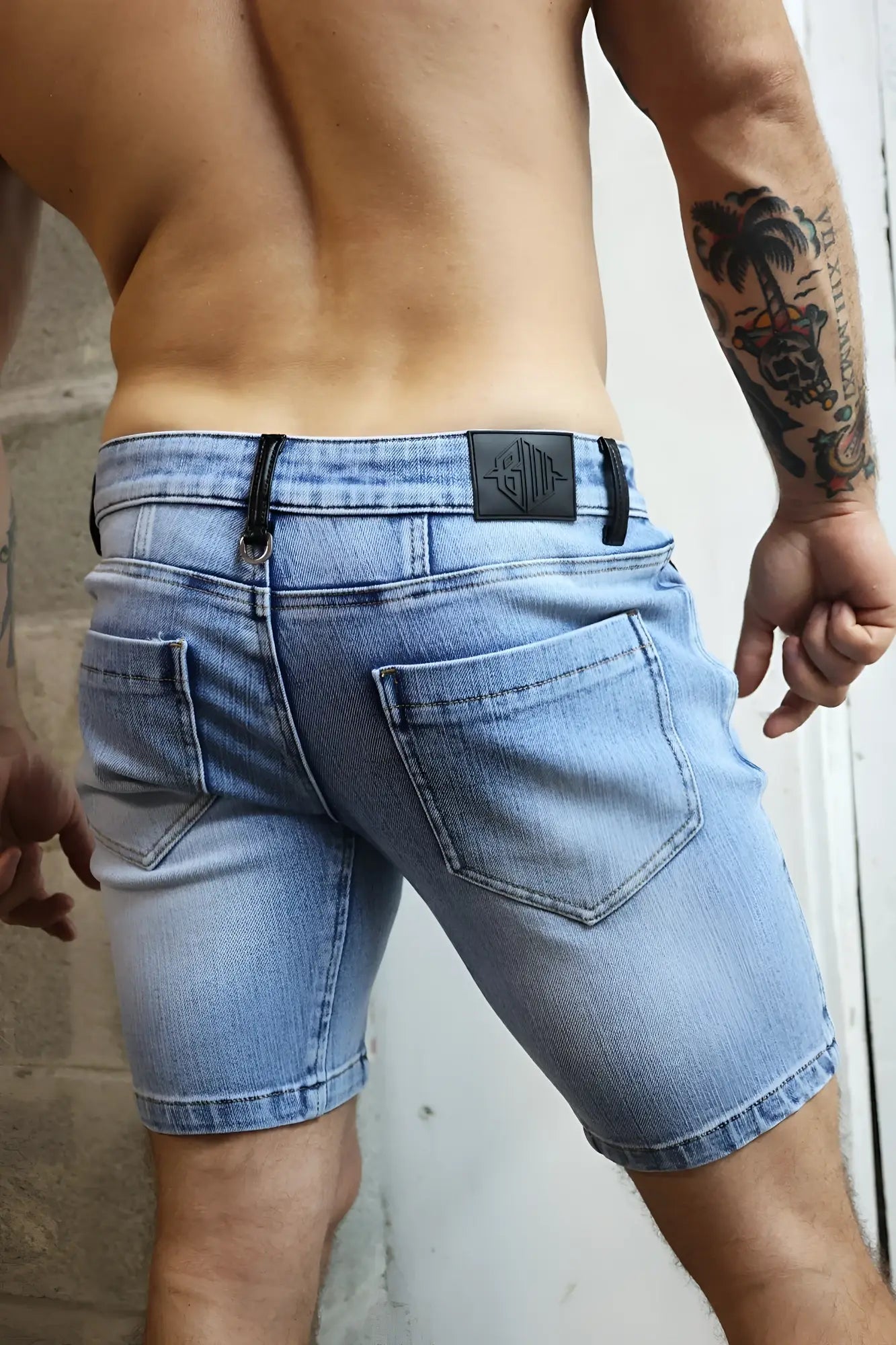 Daddys favorite shorts light-wash denim shorts with black leather patch at waistband back view