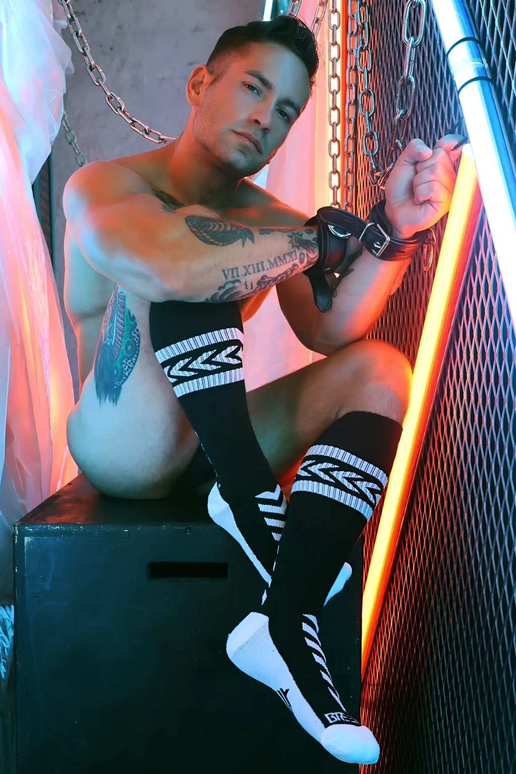 Black and white knee-high socks with geometric zigzag patterns and small logo on toe called daddys favorite socks