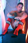 Bright red knee-high socks with bold black geometric patterns and ribbed cuff from daddys favorite socks collection
