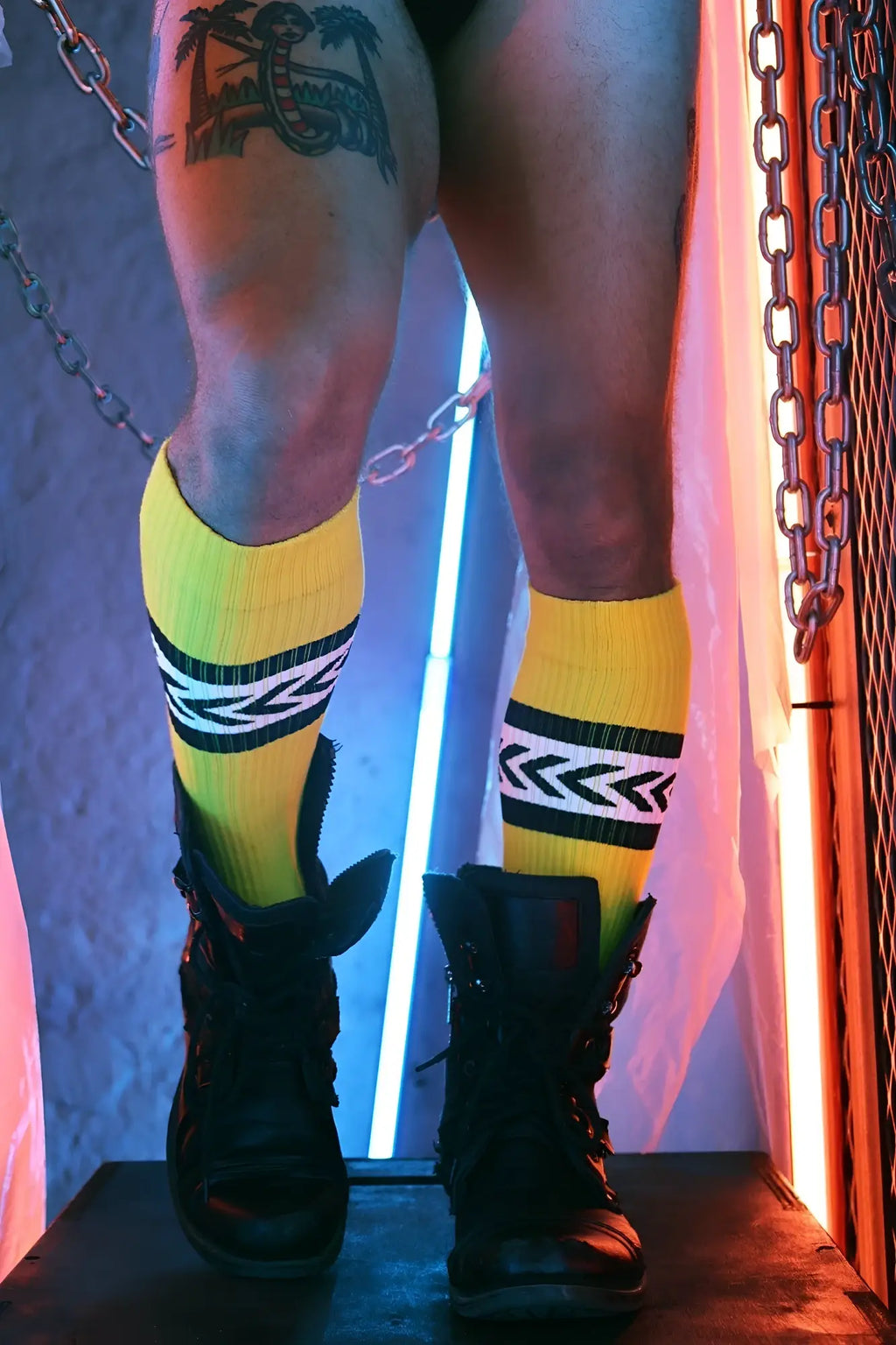 Daddys favorite socks bright yellow knee-high socks with bold black and white geometric stripes worn with rugged boots