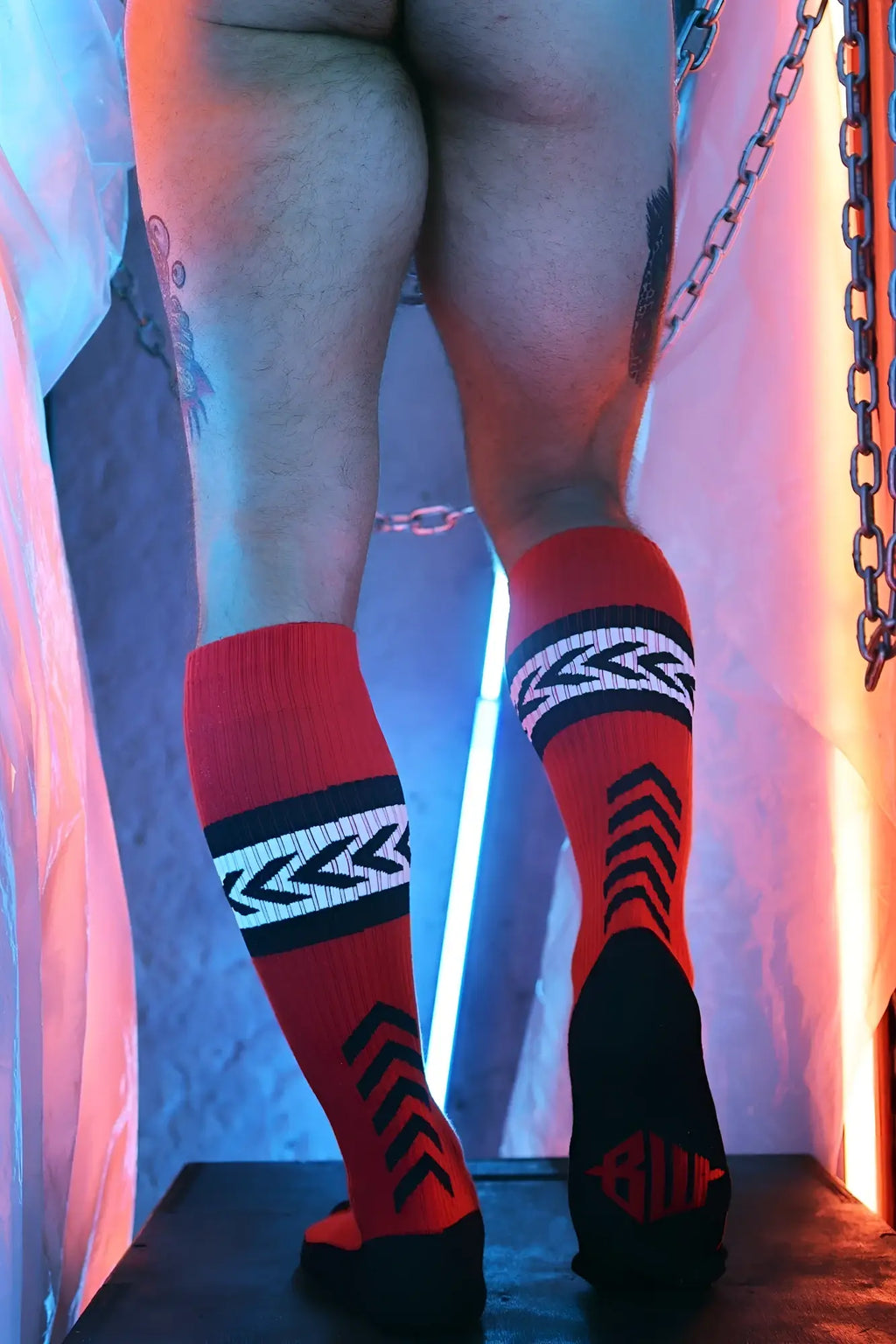 Daddys favorite socks red and black knee-high socks with bold geometric patterns and logo visible on the heel backside
