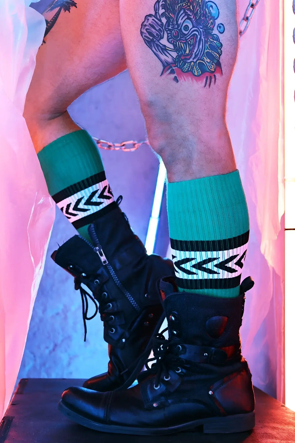 Teal and black Daddy’s Favorite athletic socks with white chevron stripes for comfortable sports use