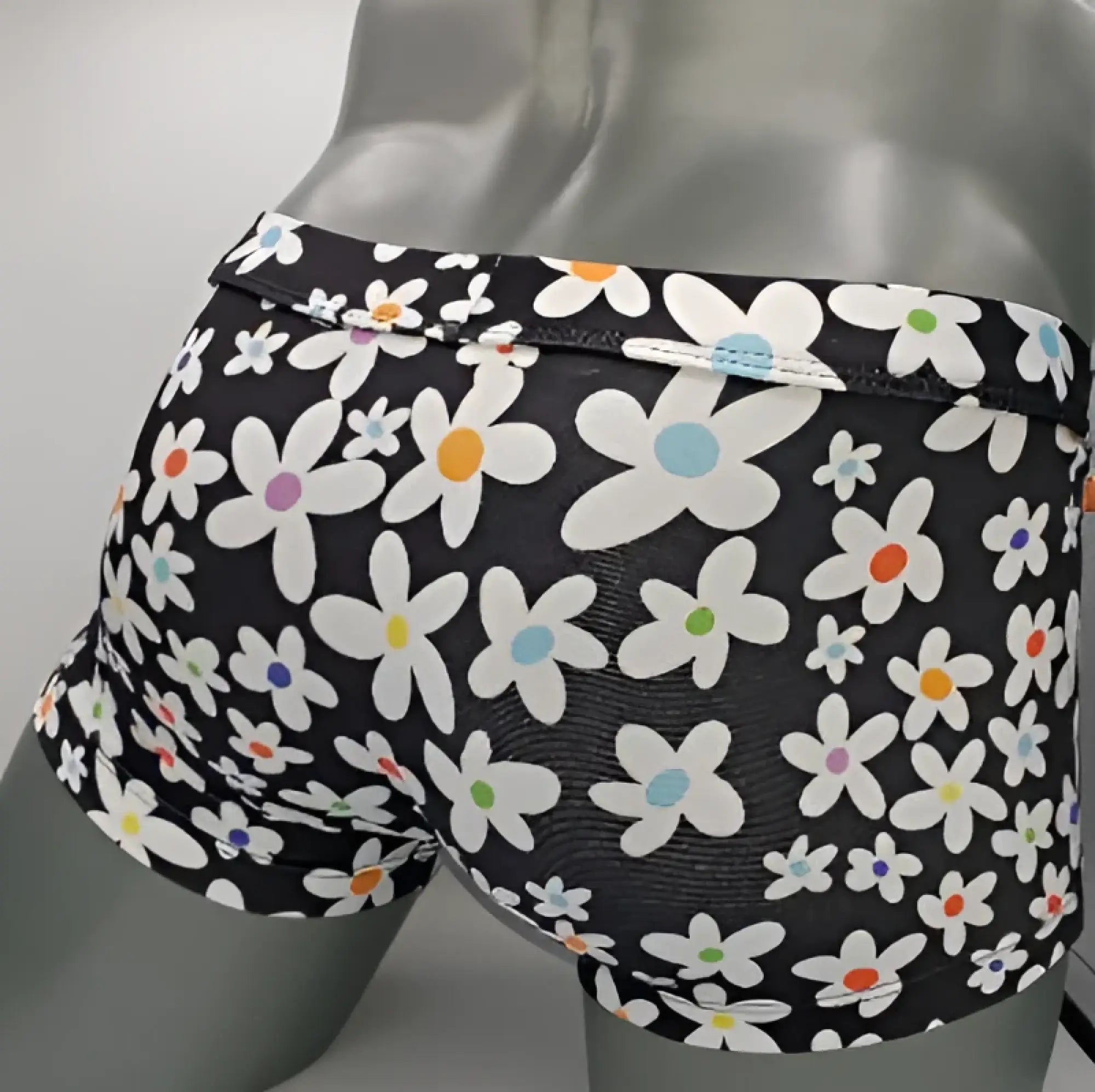 Black briefs daisy sq cut with a vibrant white daisy pattern featuring colorful pink orange blue and green centers