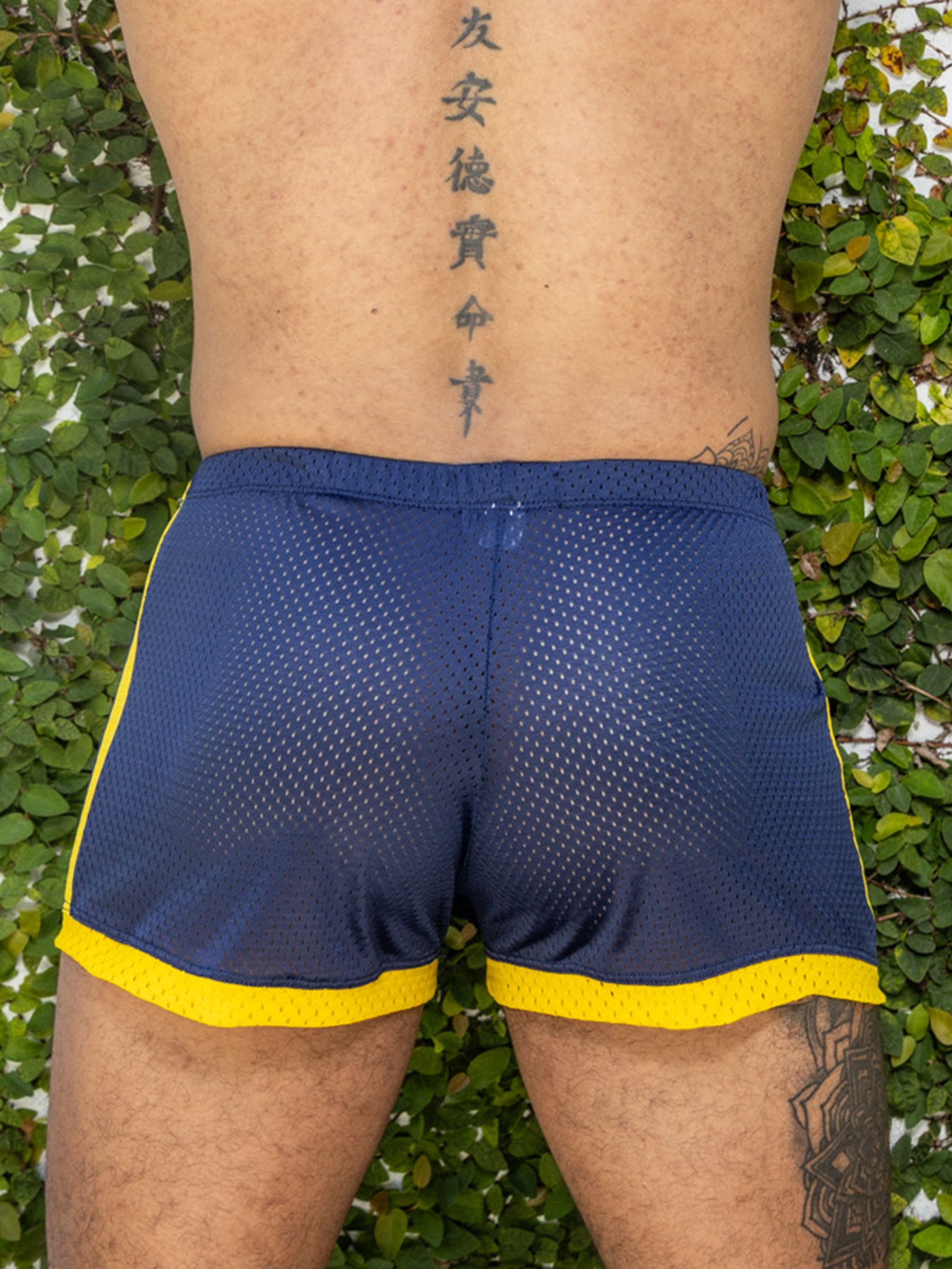 Little boy blue design dan shorts navy featuring blue and yellow perforated mesh athletic material