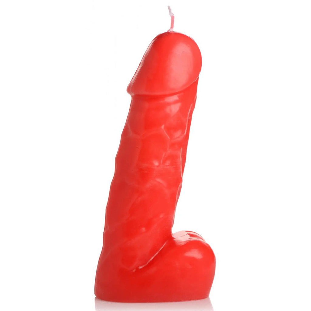 A vibrant red glossy dark pecker dick drip candle shaped like a detailed phallic form with a single wick on top