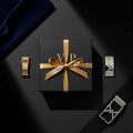 Black vip men’s fashion mystery box gift box with gold ribbon bow and embossed gold vip lettering on the lid
