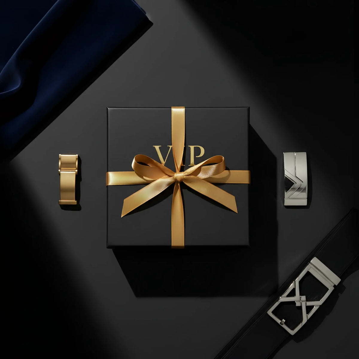 Black vip men’s fashion mystery box gift box with gold ribbon bow and embossed gold vip lettering on the lid