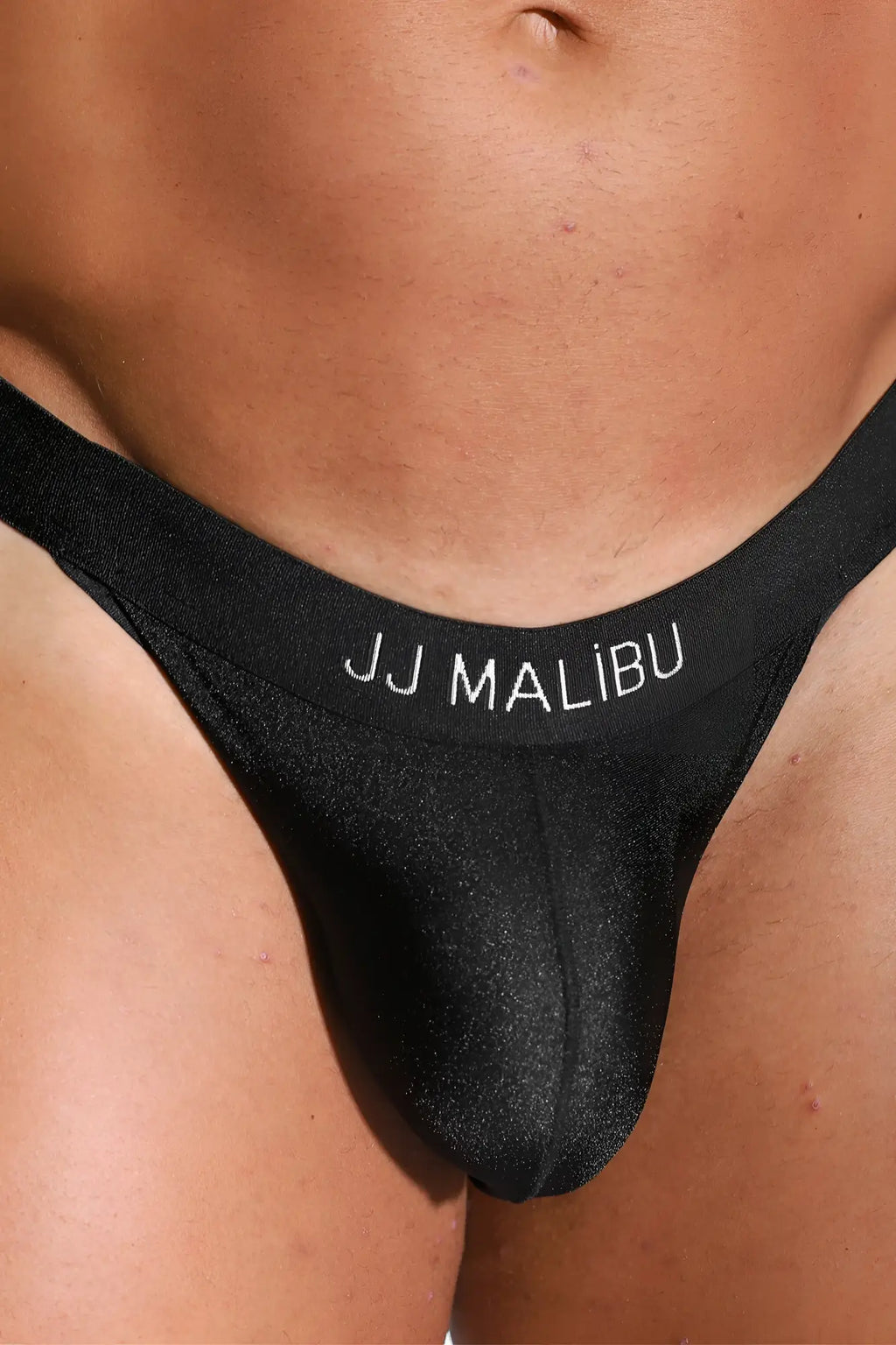 Deep back v jockstrap in obsidian black features a smooth shiny black jj malibu thong with white embroidered waistband branding