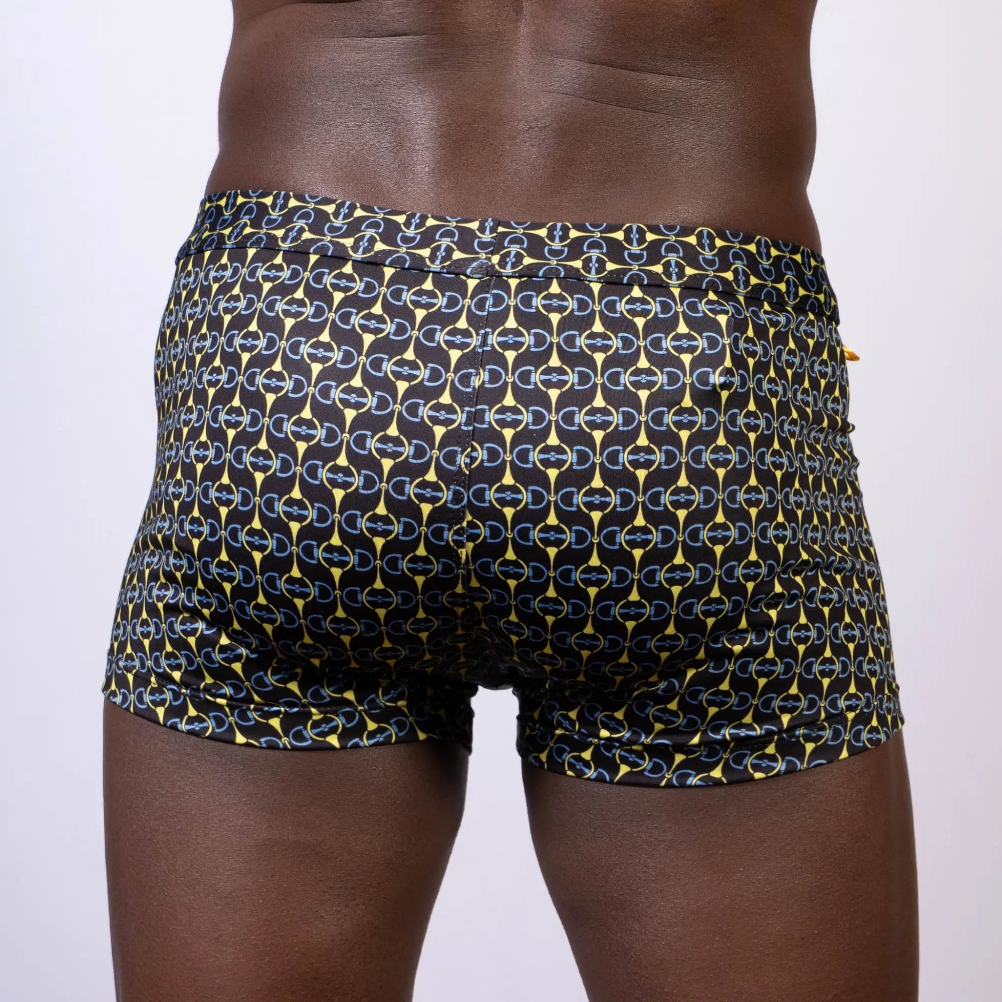 Black designer buckle print sq cut trunk swim trunks with bold yellow and blue chain-link pattern for swimming