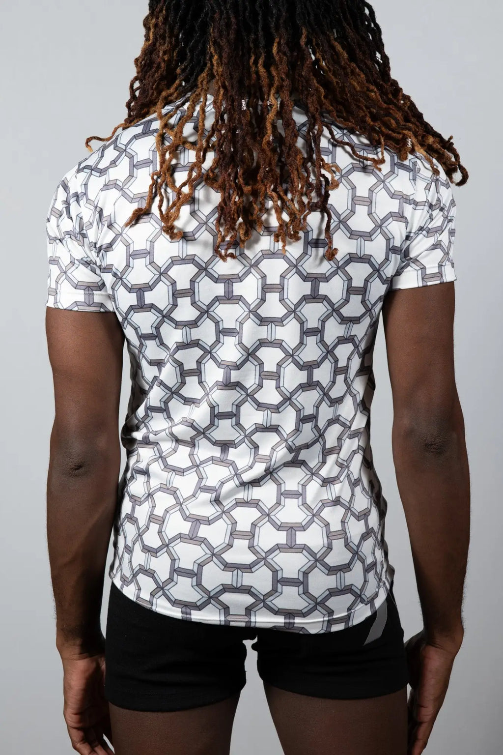 White short-sleeved designer inspired print tee with geometric gray pattern made from breathable athletic fabric