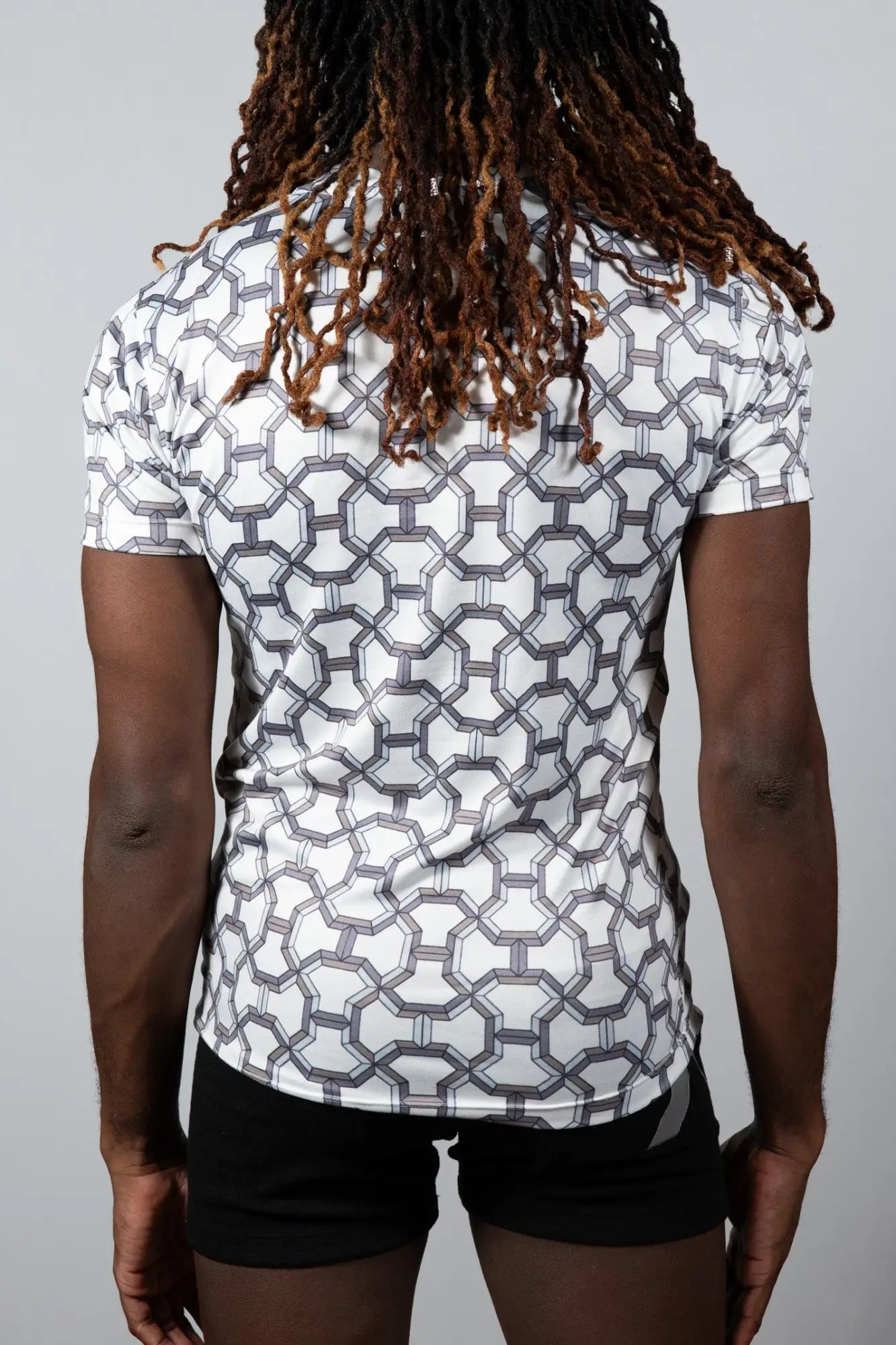 White short-sleeved designer inspired print tee with geometric gray pattern made from breathable athletic fabric