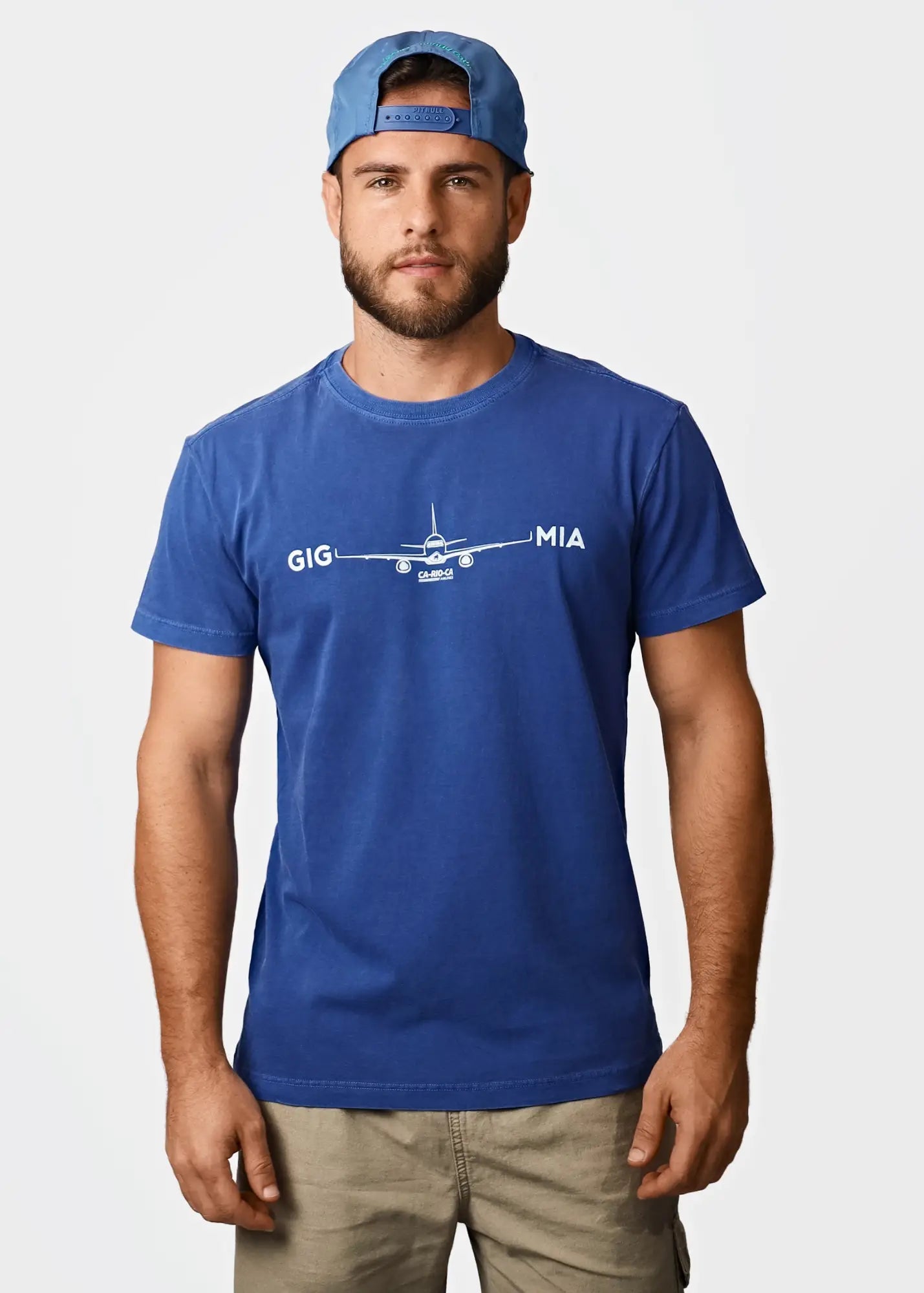 Blue cotton men’s t-shirt featuring a white airplane graphic with gig and mia text from destination mia miami collection