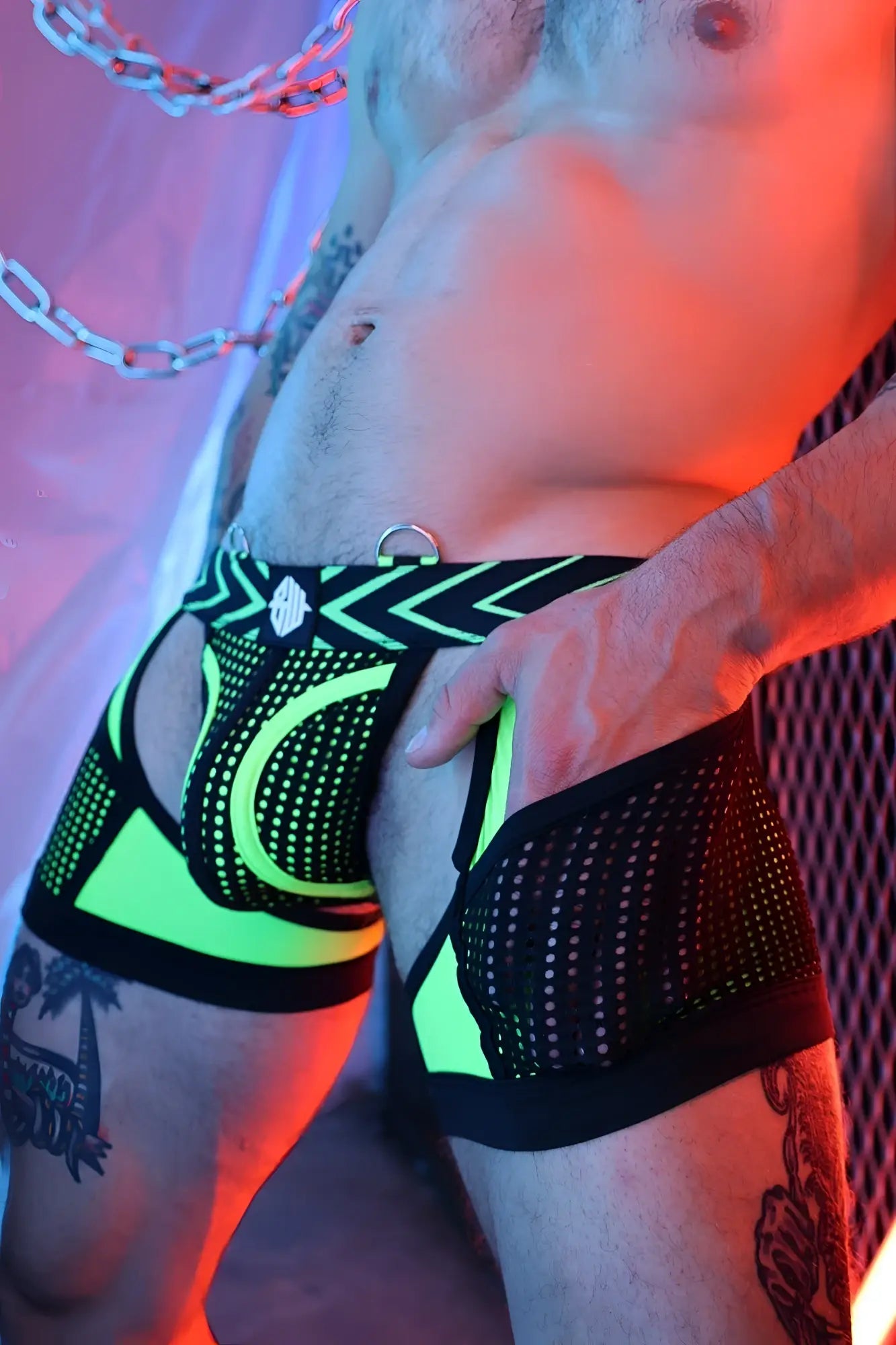 Dickmatized chock neon green and black mesh briefs with geometric pattern and metallic ring at the waistband