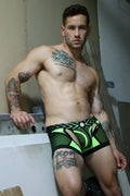 Neon green and black patterned men’s briefs with bold geometric design from Dickmatized Chock collection