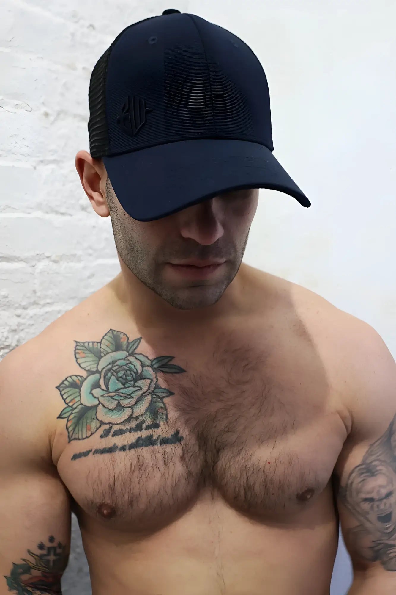 Black trucker-style baseball cap with mesh back and embroidered dirty trucker hat logo on front