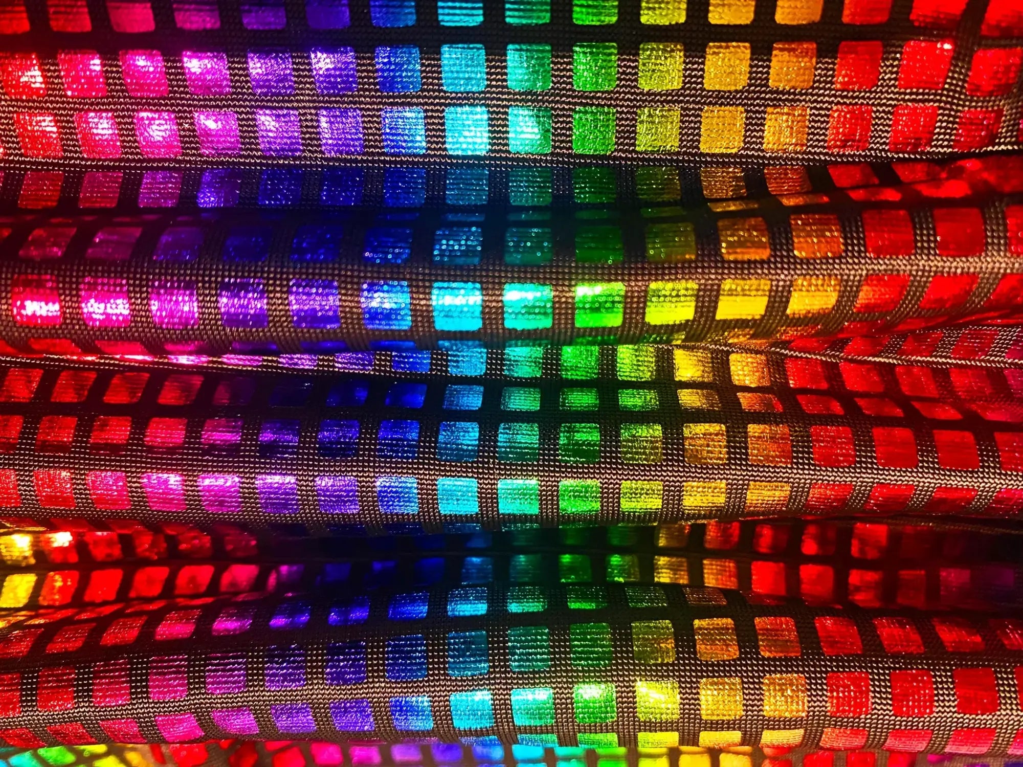Disco queen tank featuring rainbow-colored holographic fabric with a grid of shimmering reflective squares