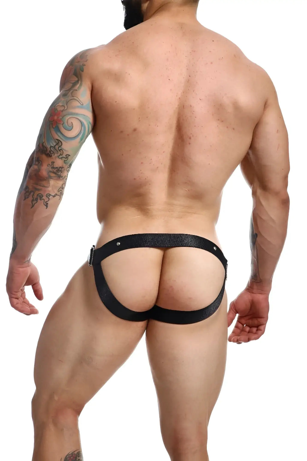 Black leather harness-style briefs with textured surface and metallic hardware from DNGEON C-ring Jockstrap Animal