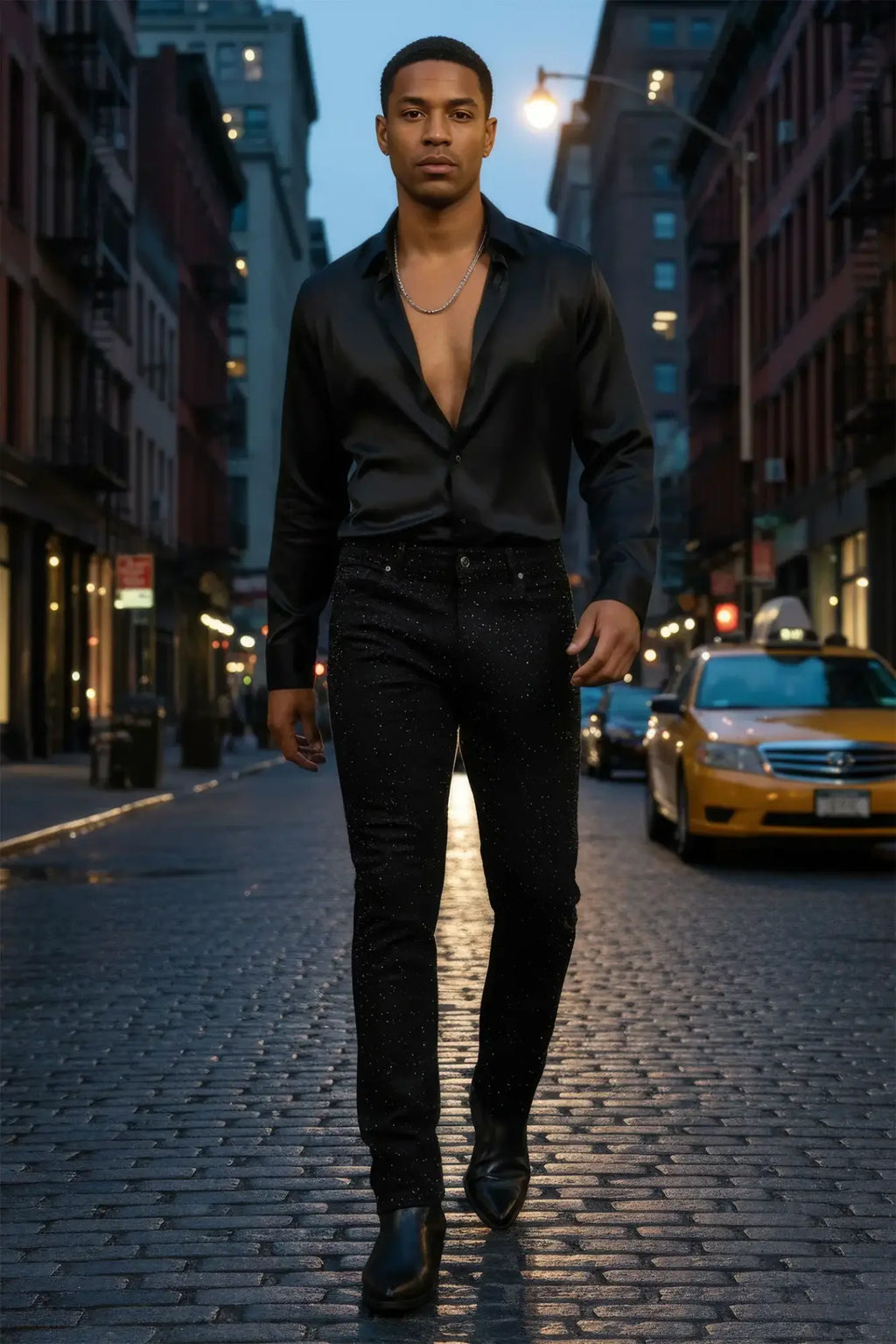 Black satin shirt with deep v-neckline and long sleeves paired with Dolorosa rhinestone jeans