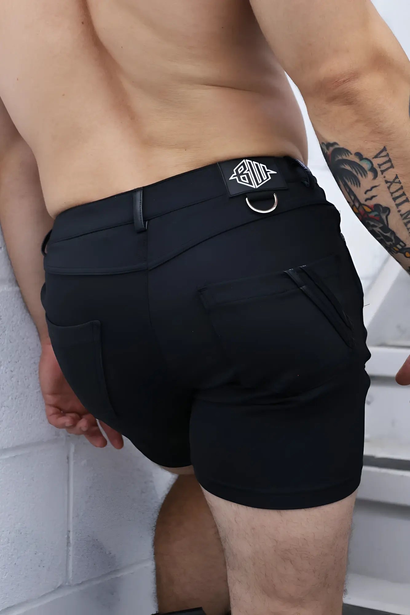Black down low shorts featuring sleek modern design and branded patch on waistband for athletic use