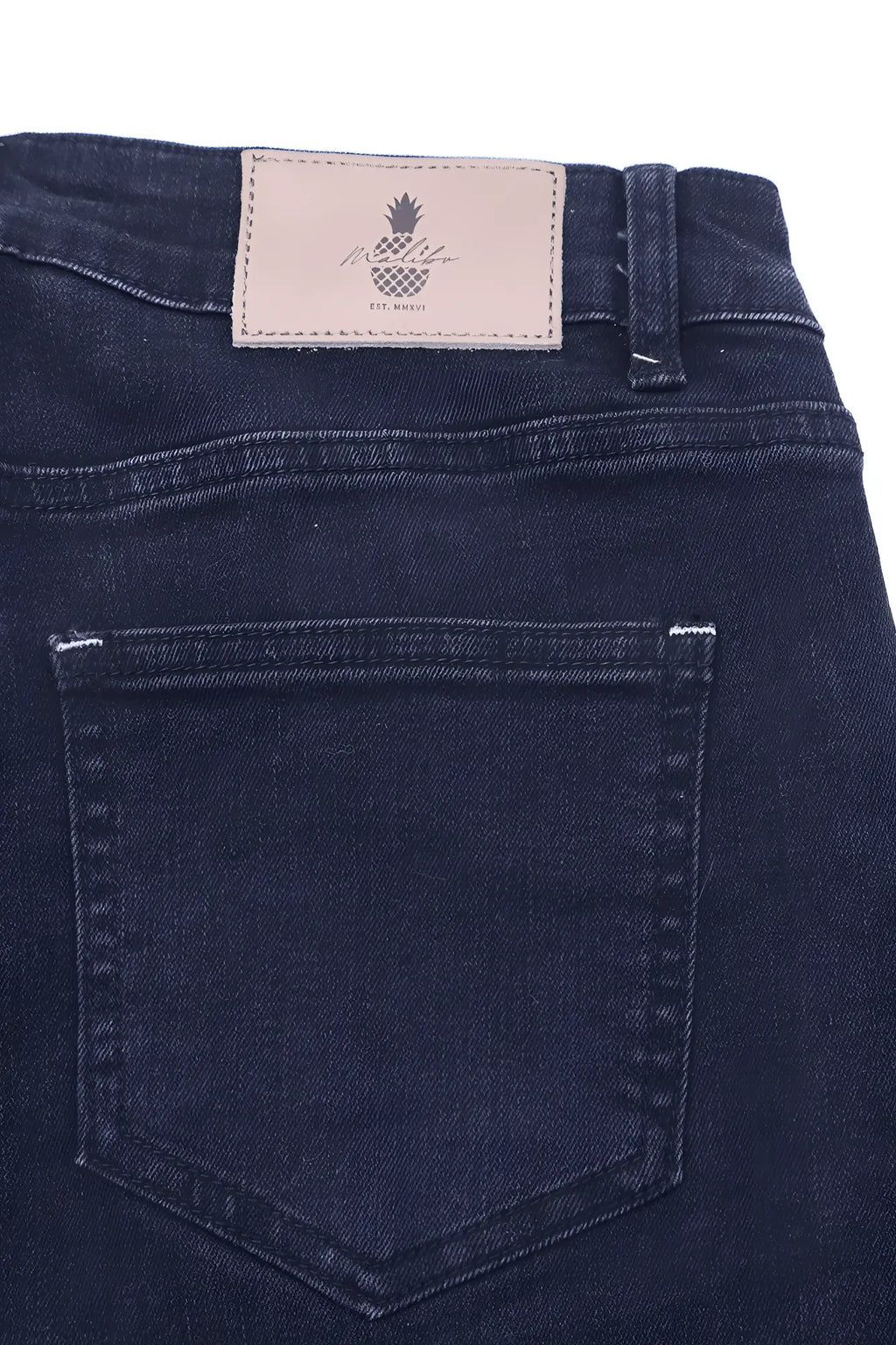 Dark blue denim jeans with beige leather patch featuring pineapple logo and pineapple text on the back side