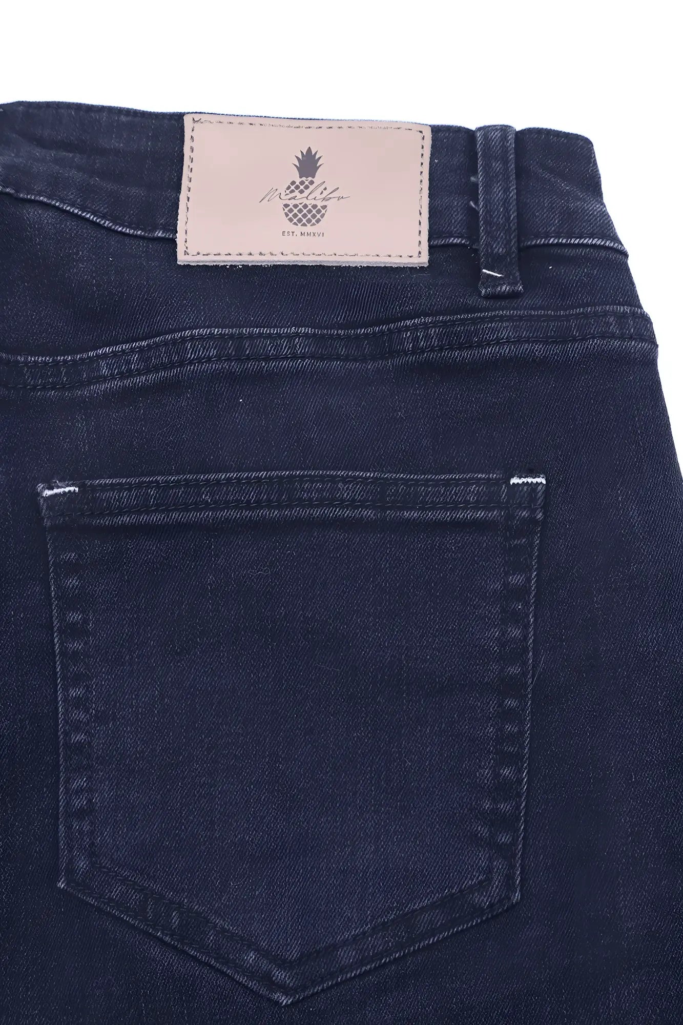 Dark blue denim jeans with beige leather patch featuring pineapple logo and pineapple text on the back side