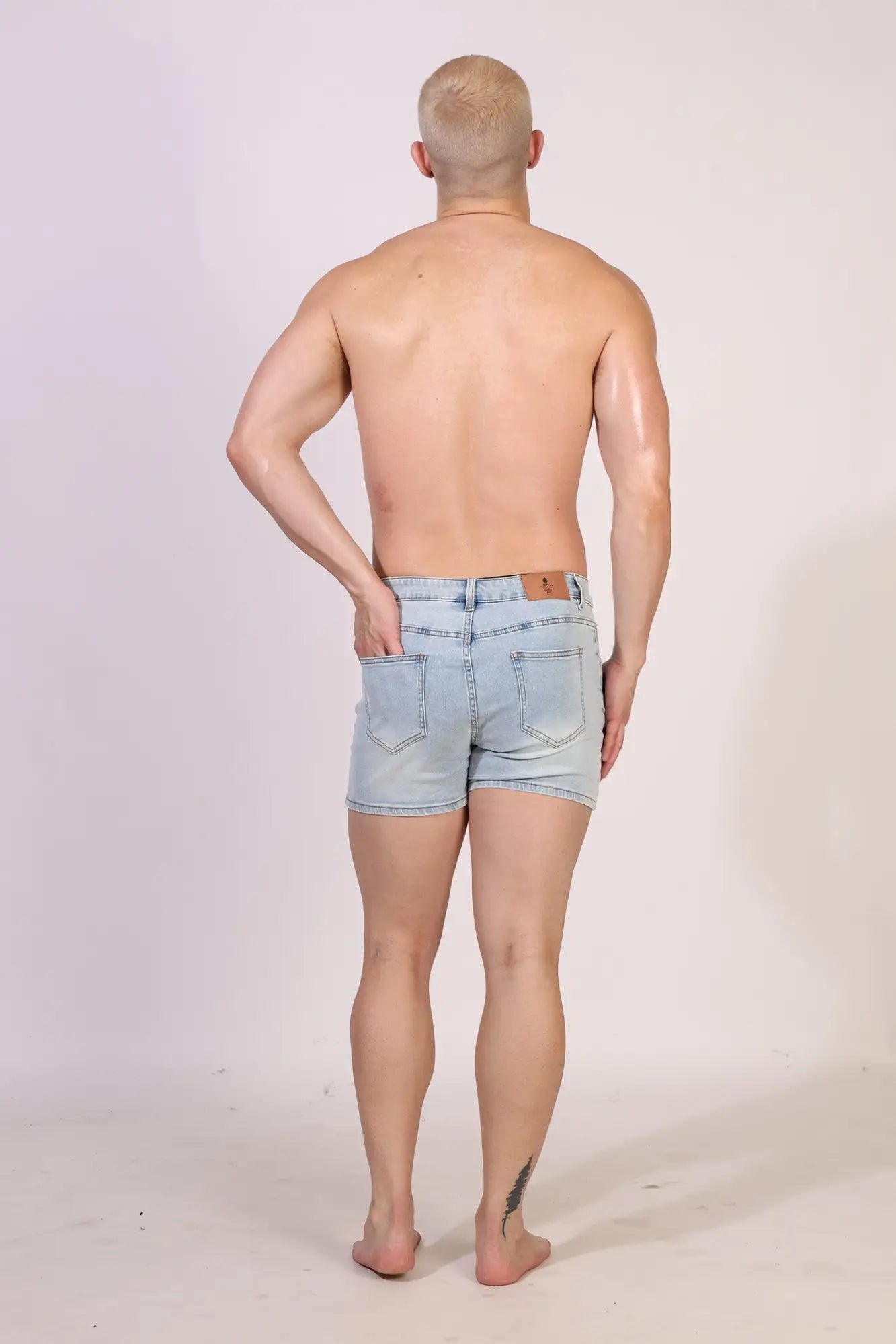 Light-wash denim in-your-dreams 3.5 inch short shorts with five-pocket design and brown leather patch on back waistband