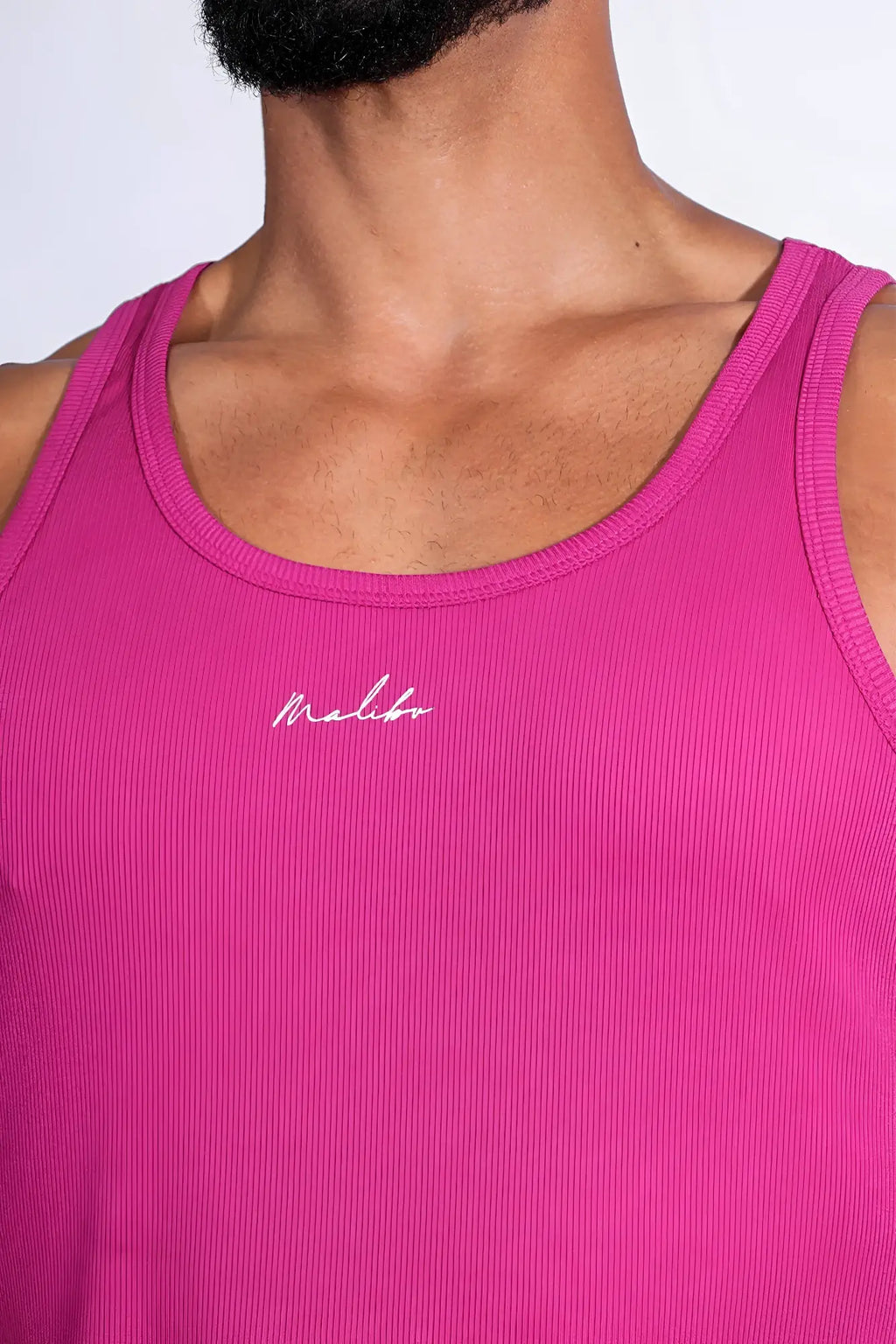 Dreamy muscle fit ribbed cropped tank in vibrant dark pink with subtle white cursive logo embroidered on chest