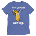 Blue heathered t-shirt featuring a cartoon glass of orange juice with lemon slice and straw with drink your juice shelby text