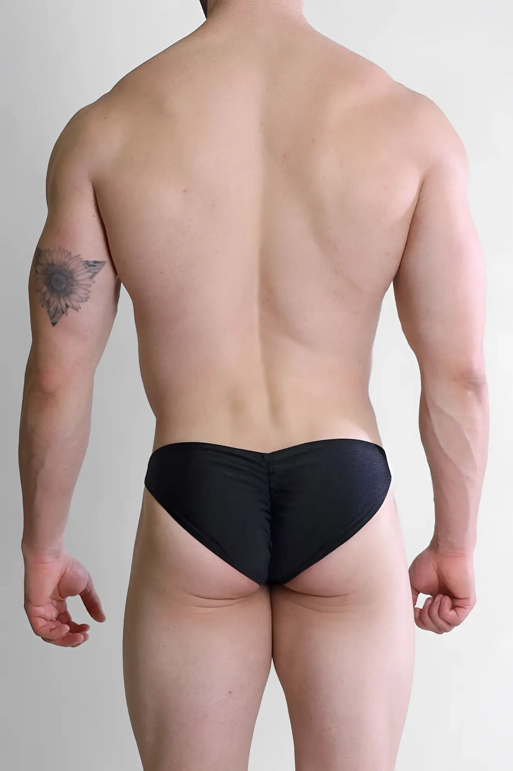 Black ruched swim trunks with scrunch butt detail in jet black for dynamic classic brief style swimwear