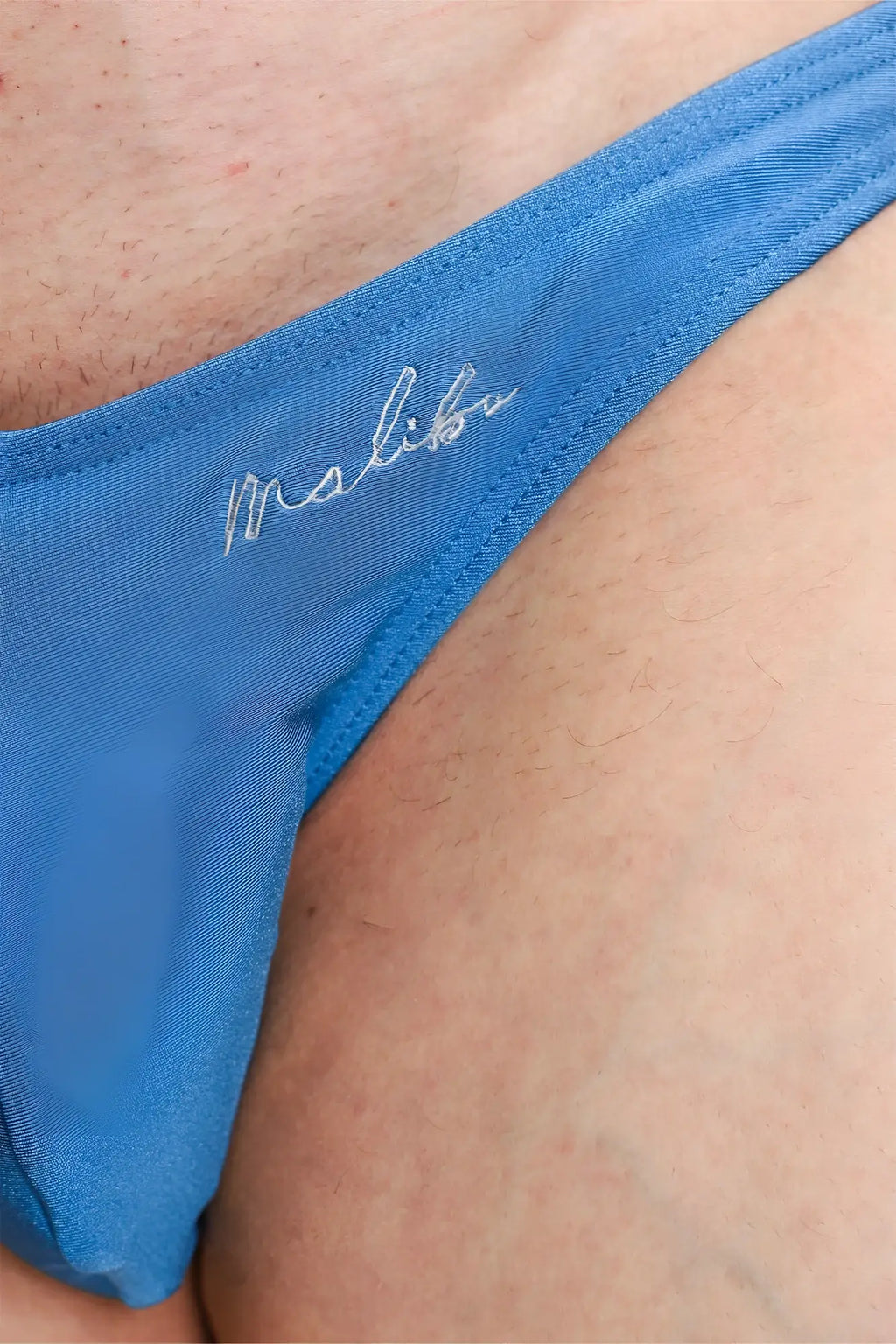 Dynamic classic scrunch-butt brief neon blue thong with subtle satin finish and delicate white embroidery waistband