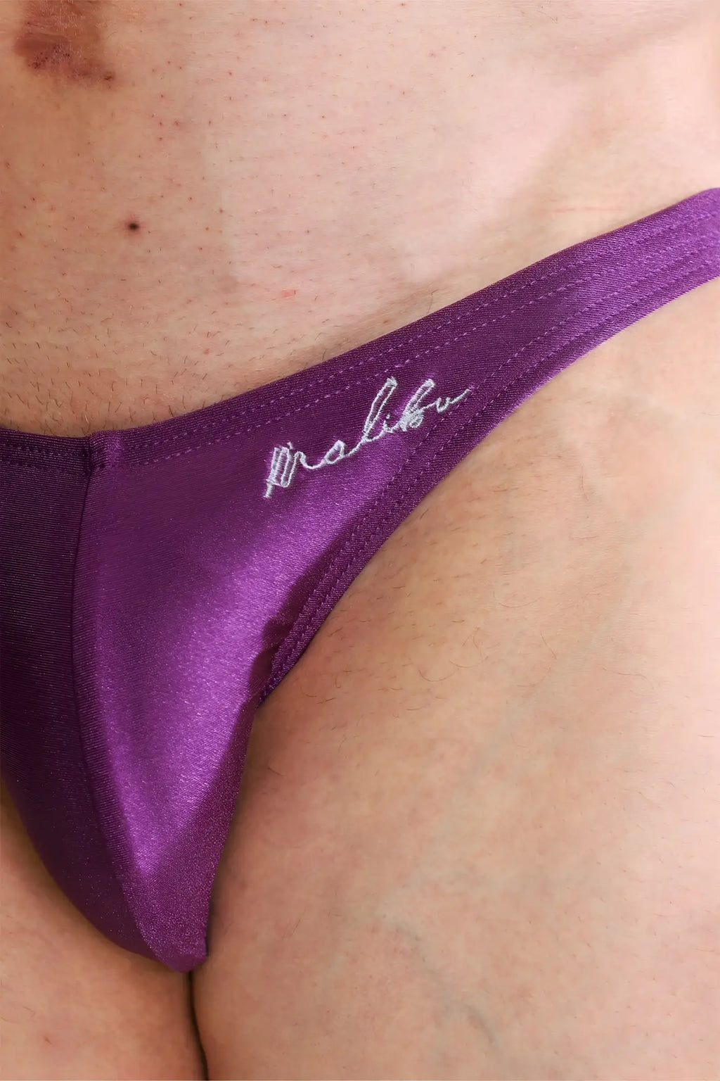 Purple satin dynamic classic scrunch-butt thong with white malibu cursive embroidery on the back side