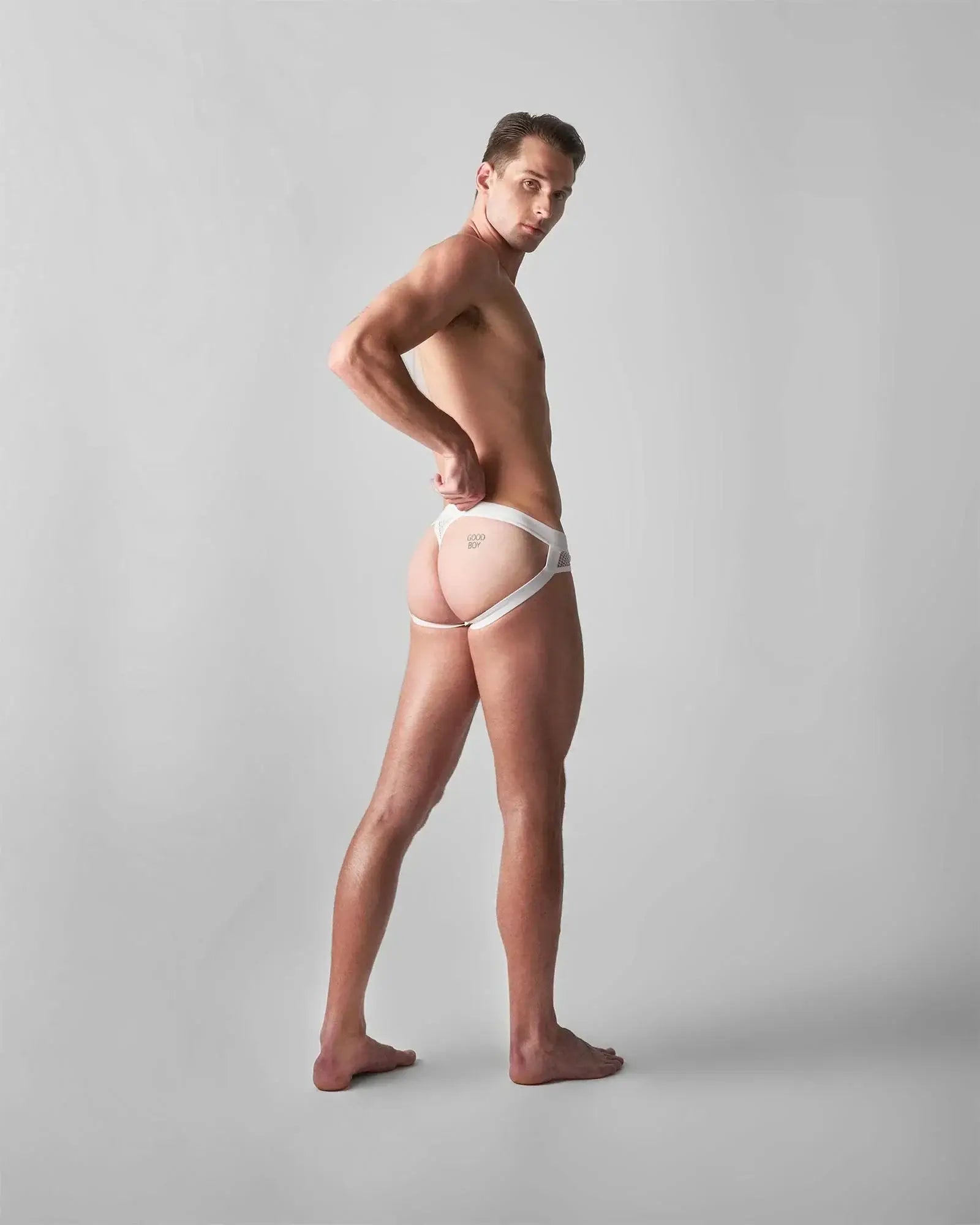 White lace-trimmed briefs with minimalist design and subtle branding on front from edge net jock thong collection